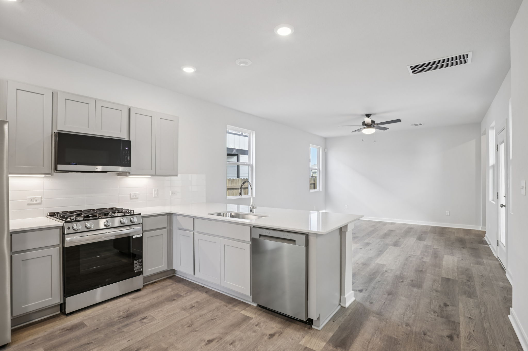A kitchen with white cabinets.