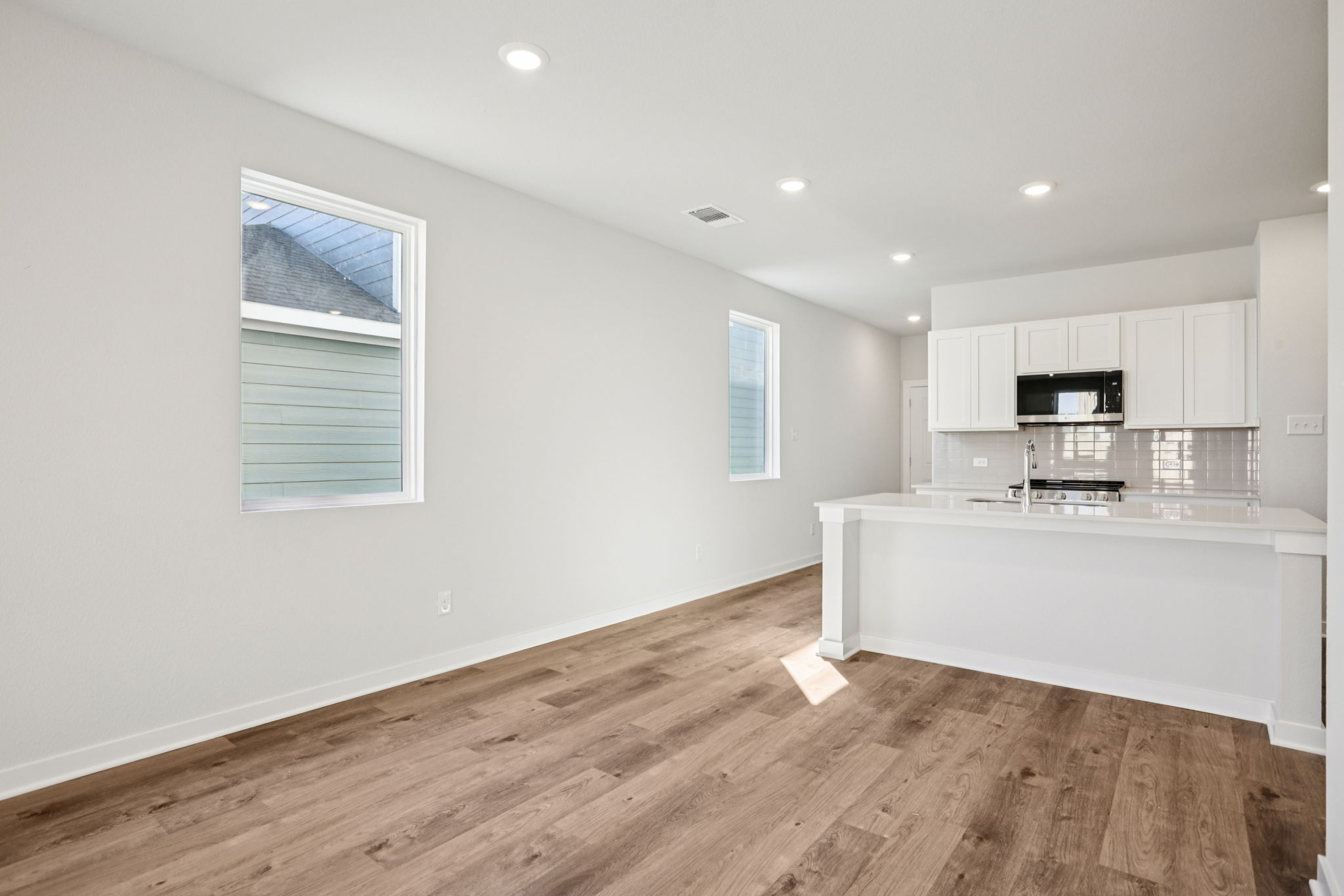 A kitchen with white cabinets.