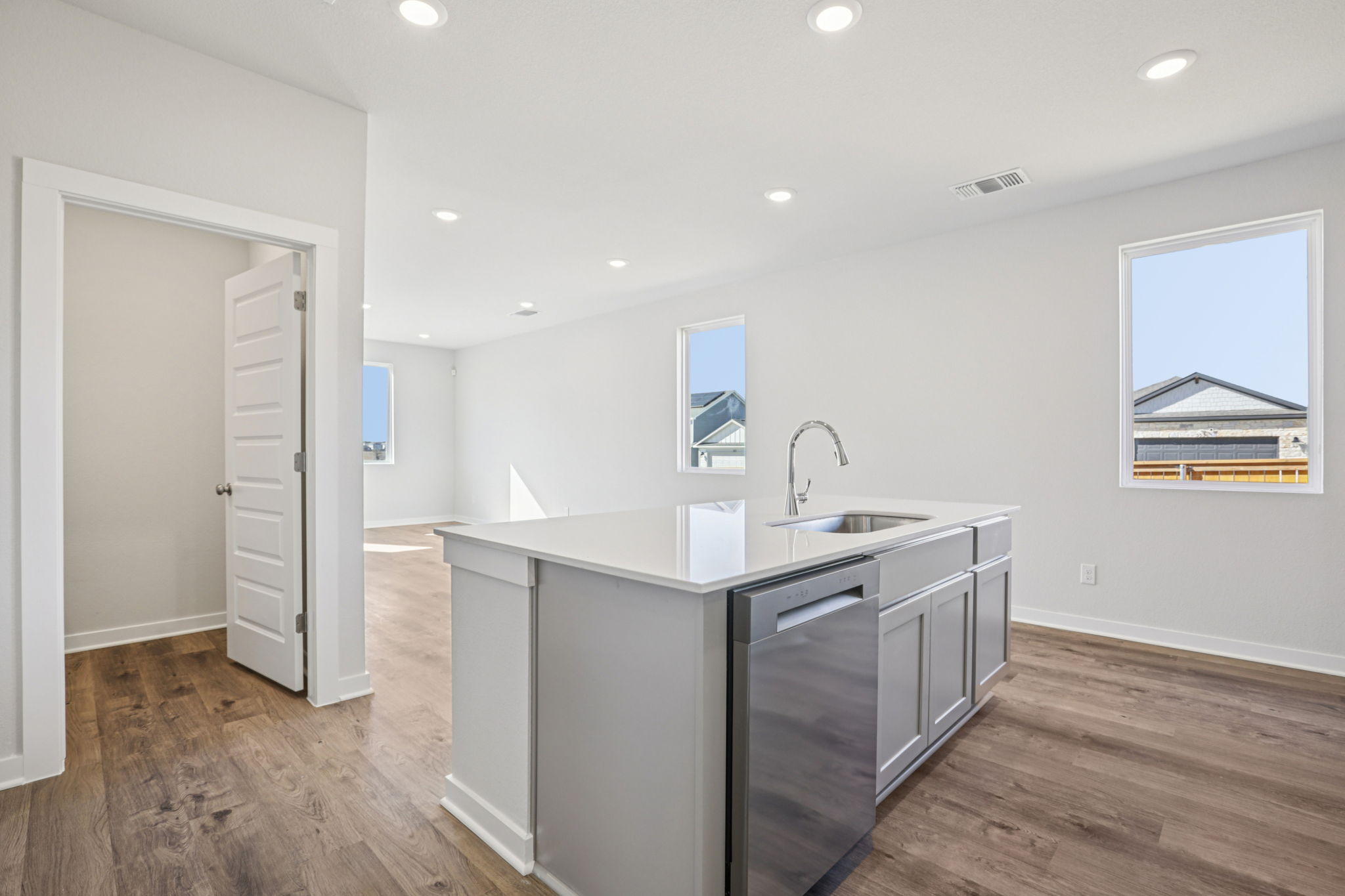 A kitchen with white cabinets.