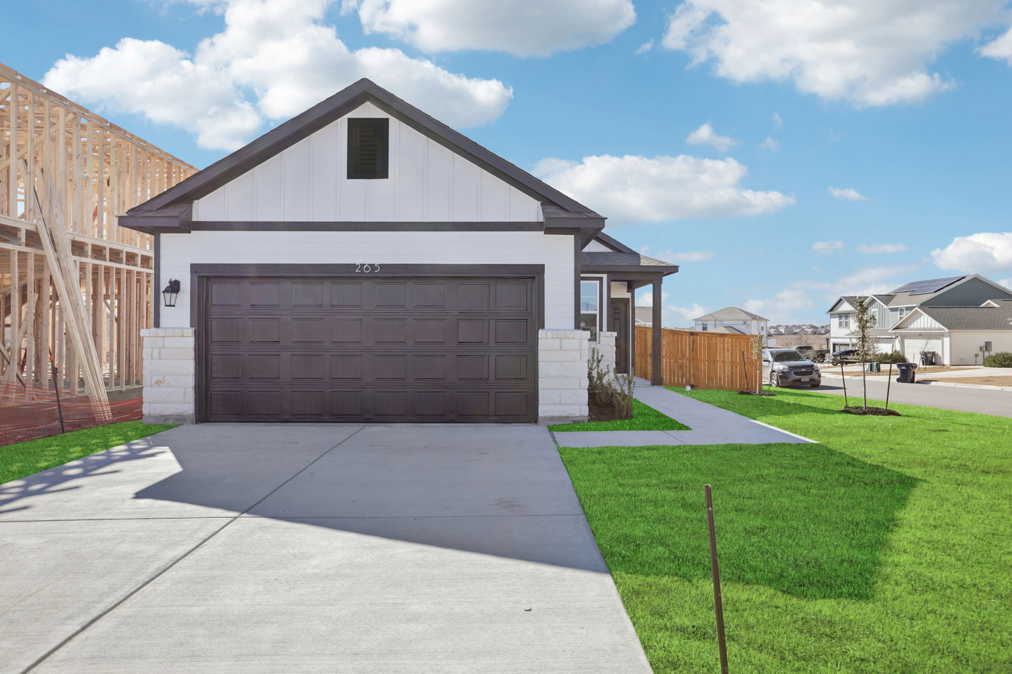 A white house with a garage.
