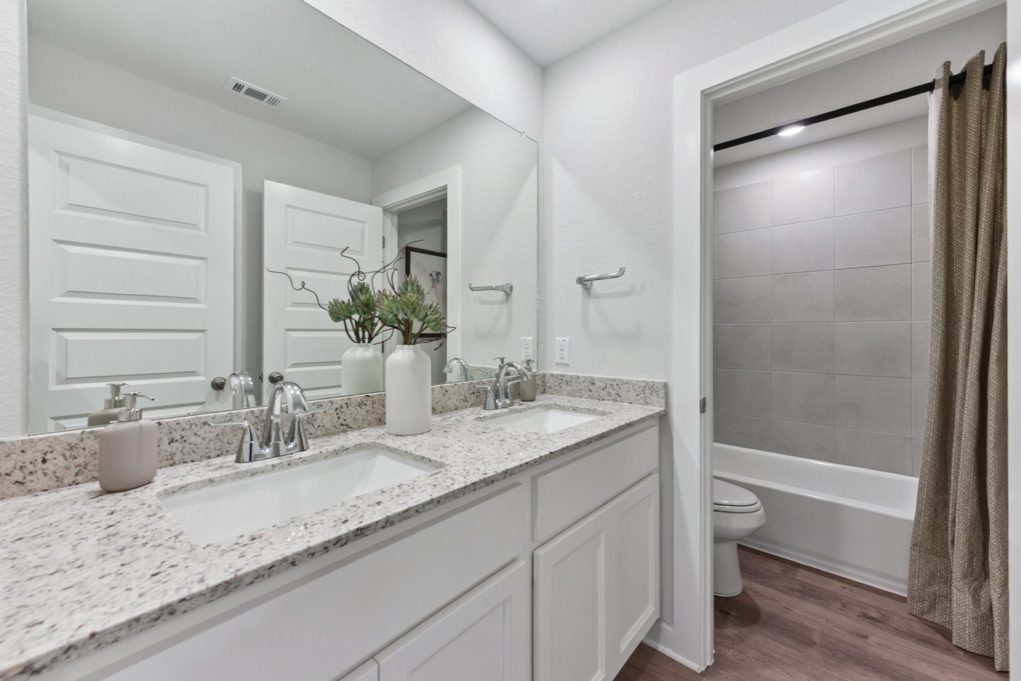 A bathroom with a tub sink and toilet.