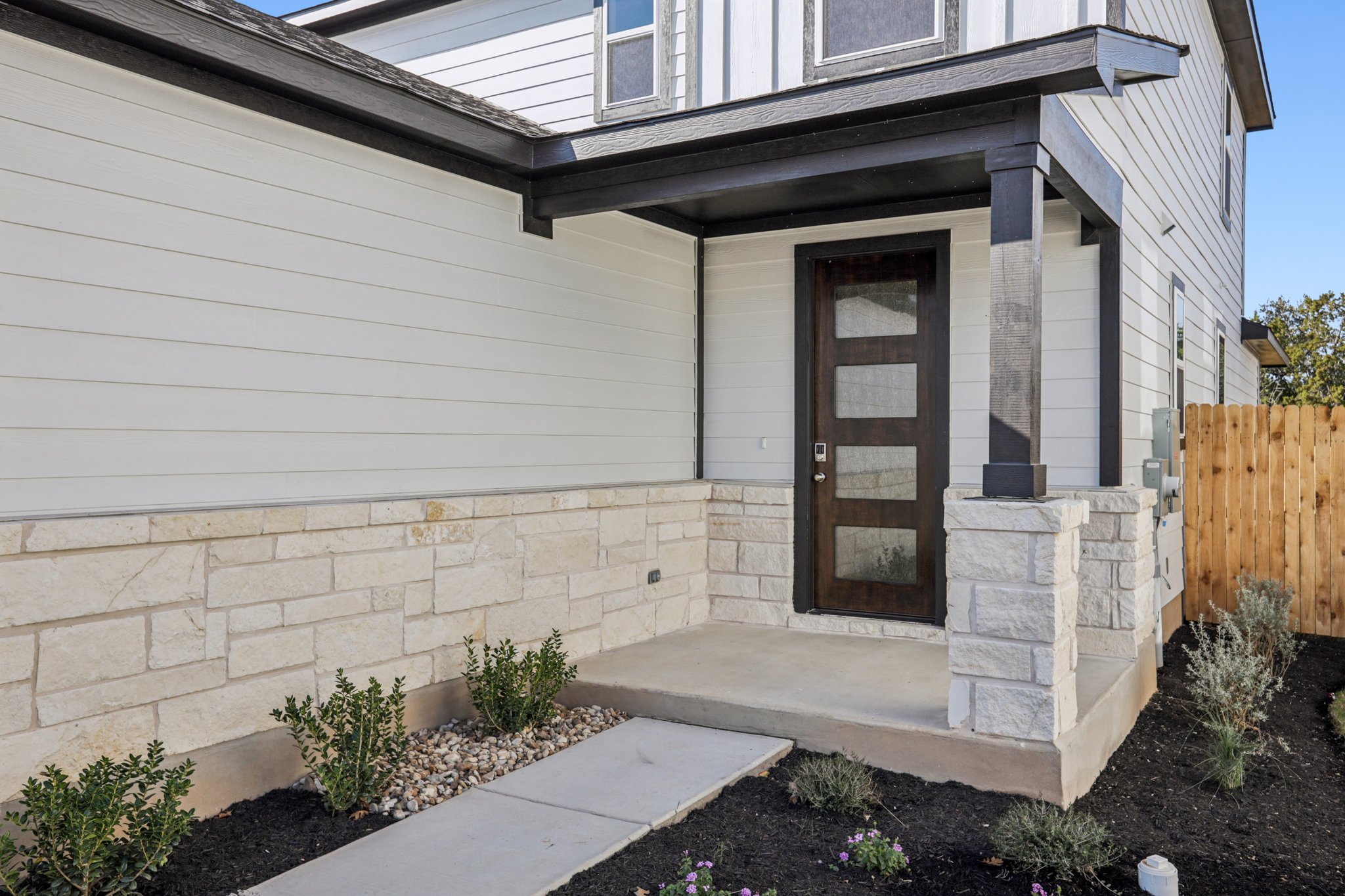A house with a stone patio.