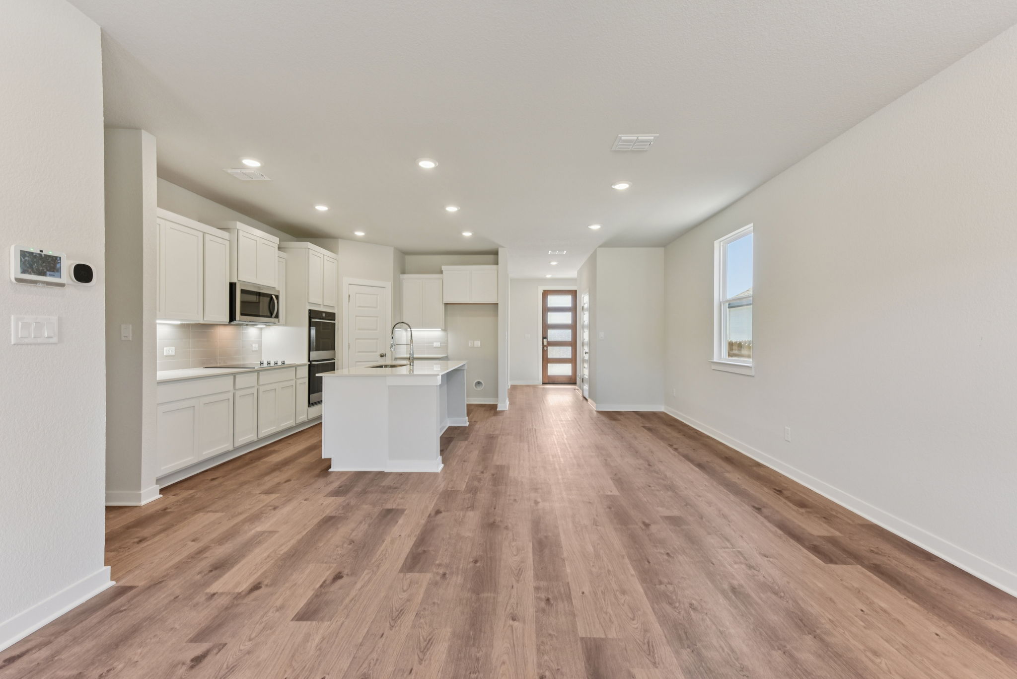 A large kitchen with white cabinets.