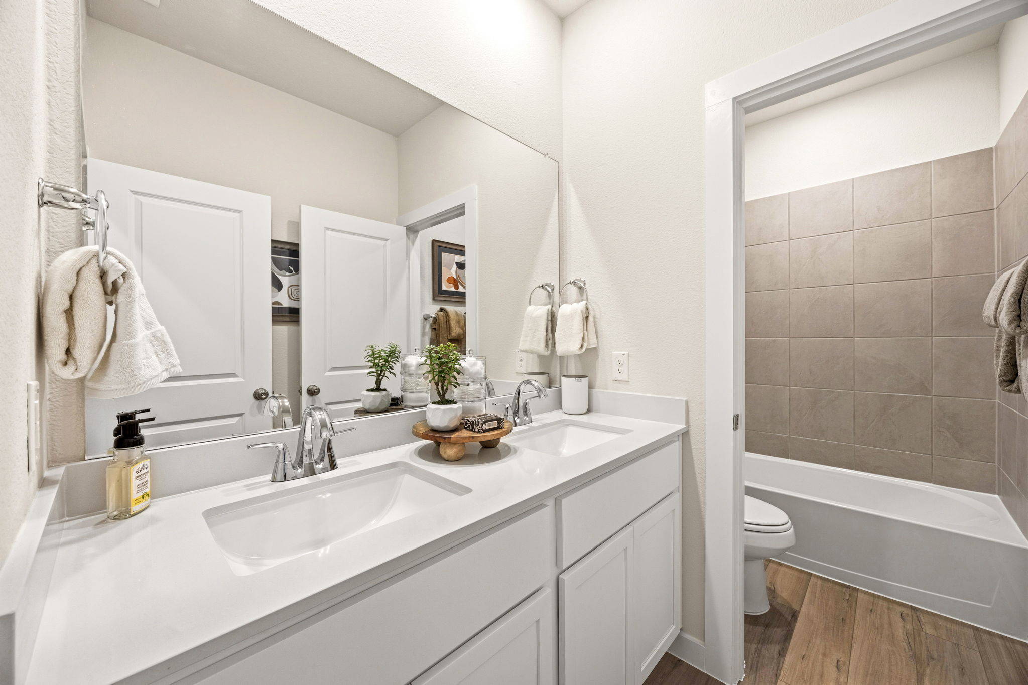 A bathroom with a tub sink and toilet.