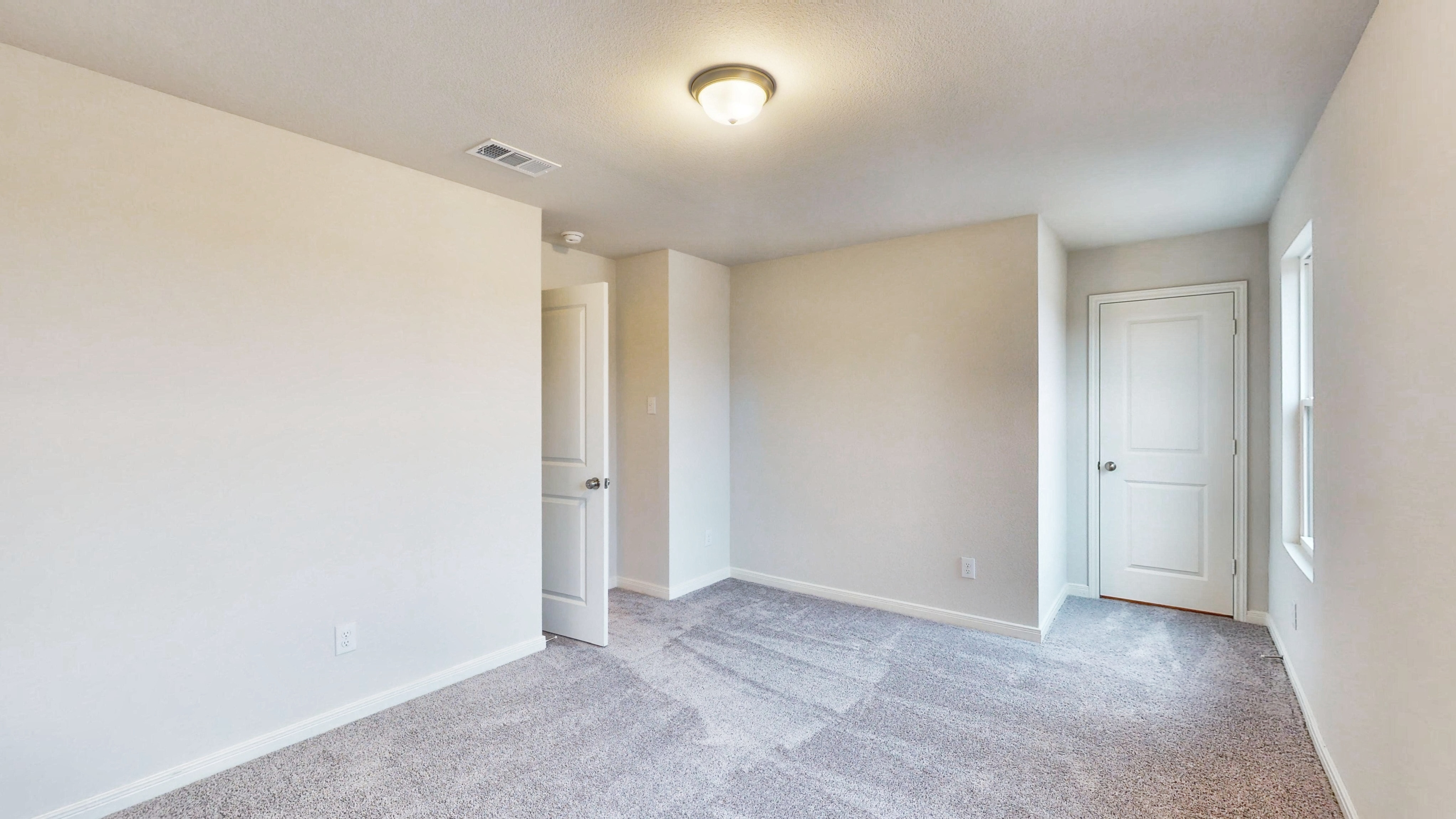 A hallway with white doors.