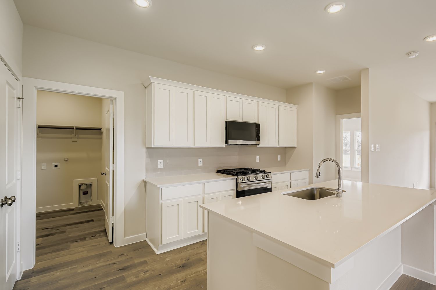 A kitchen with white cabinets.