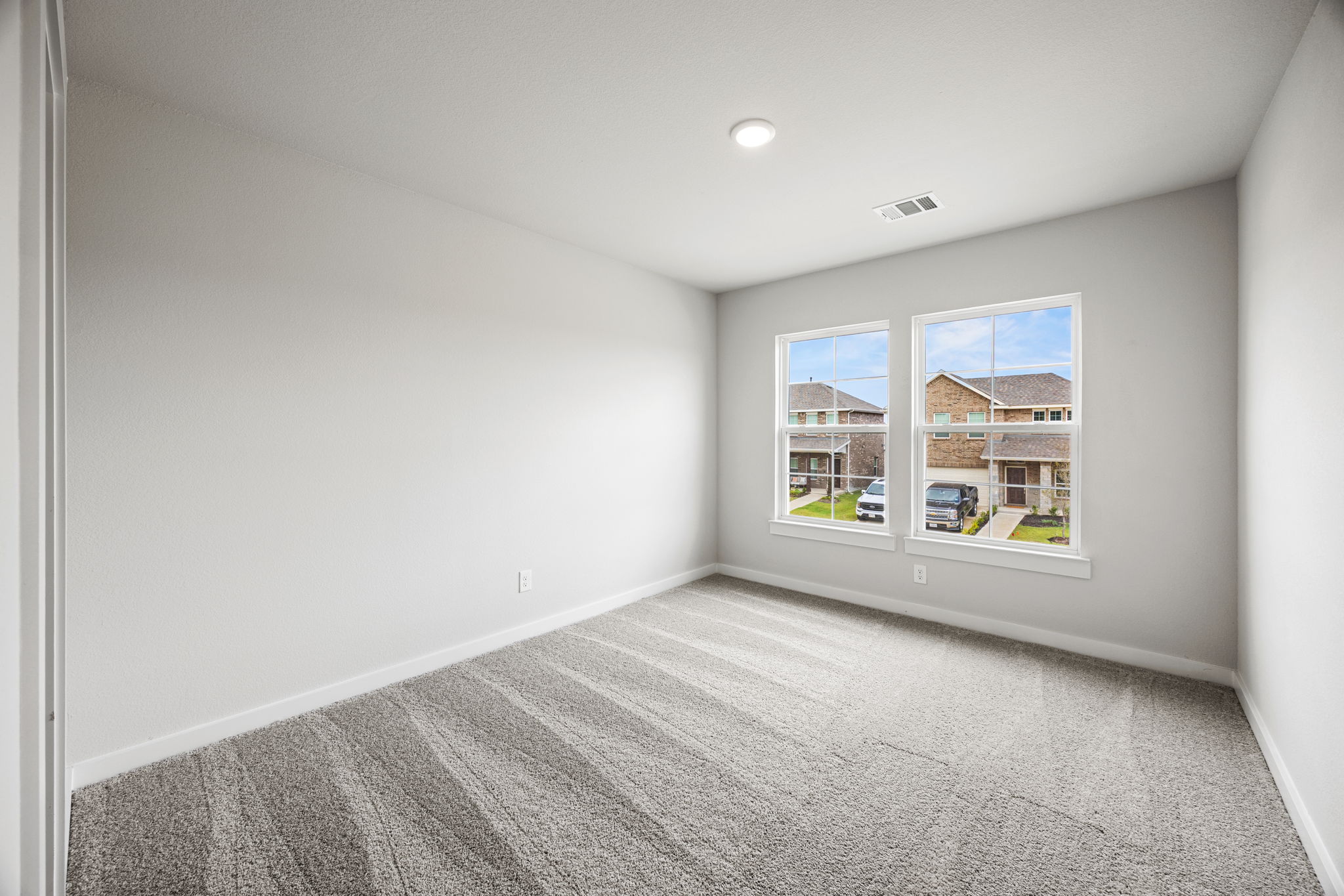A room with a window and a carpet.
