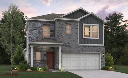 A house with a garage and trees.