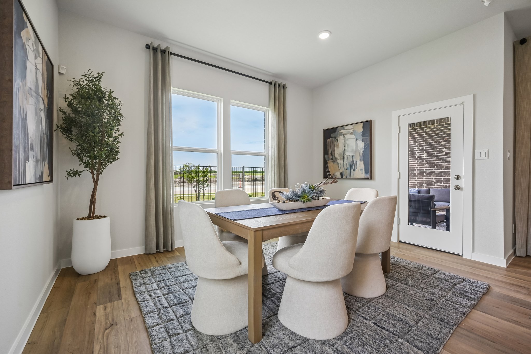 A living room with a table and chairs.