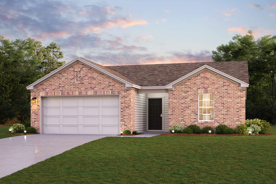 A brick house with a garage.