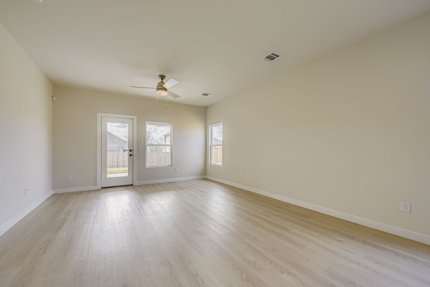A room with a wood floor and a ceiling fan.