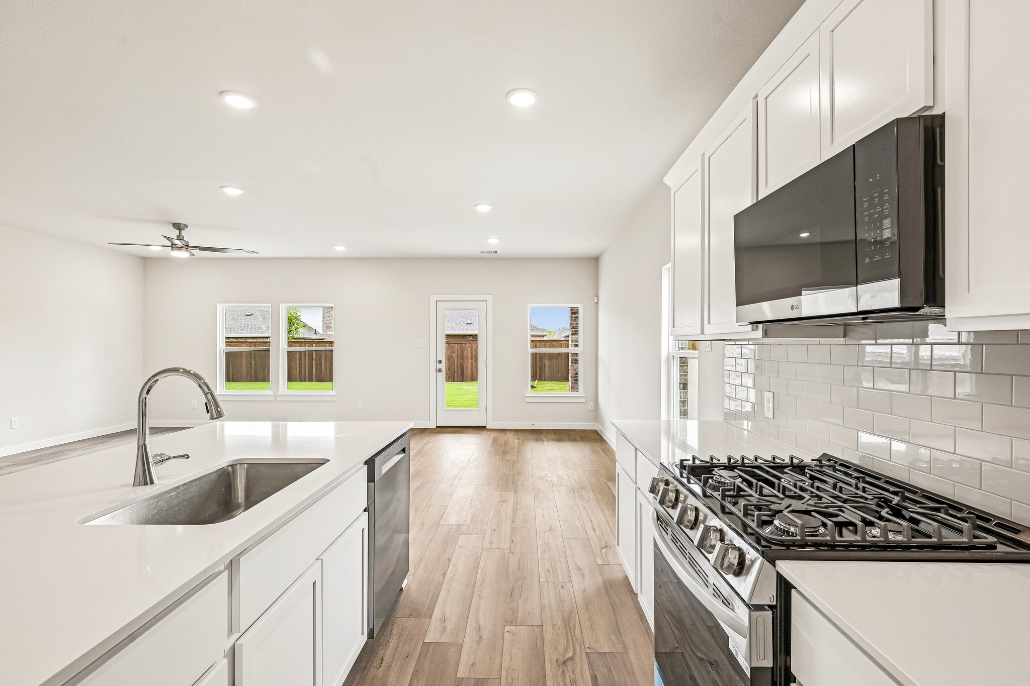 A kitchen with white cabinets.