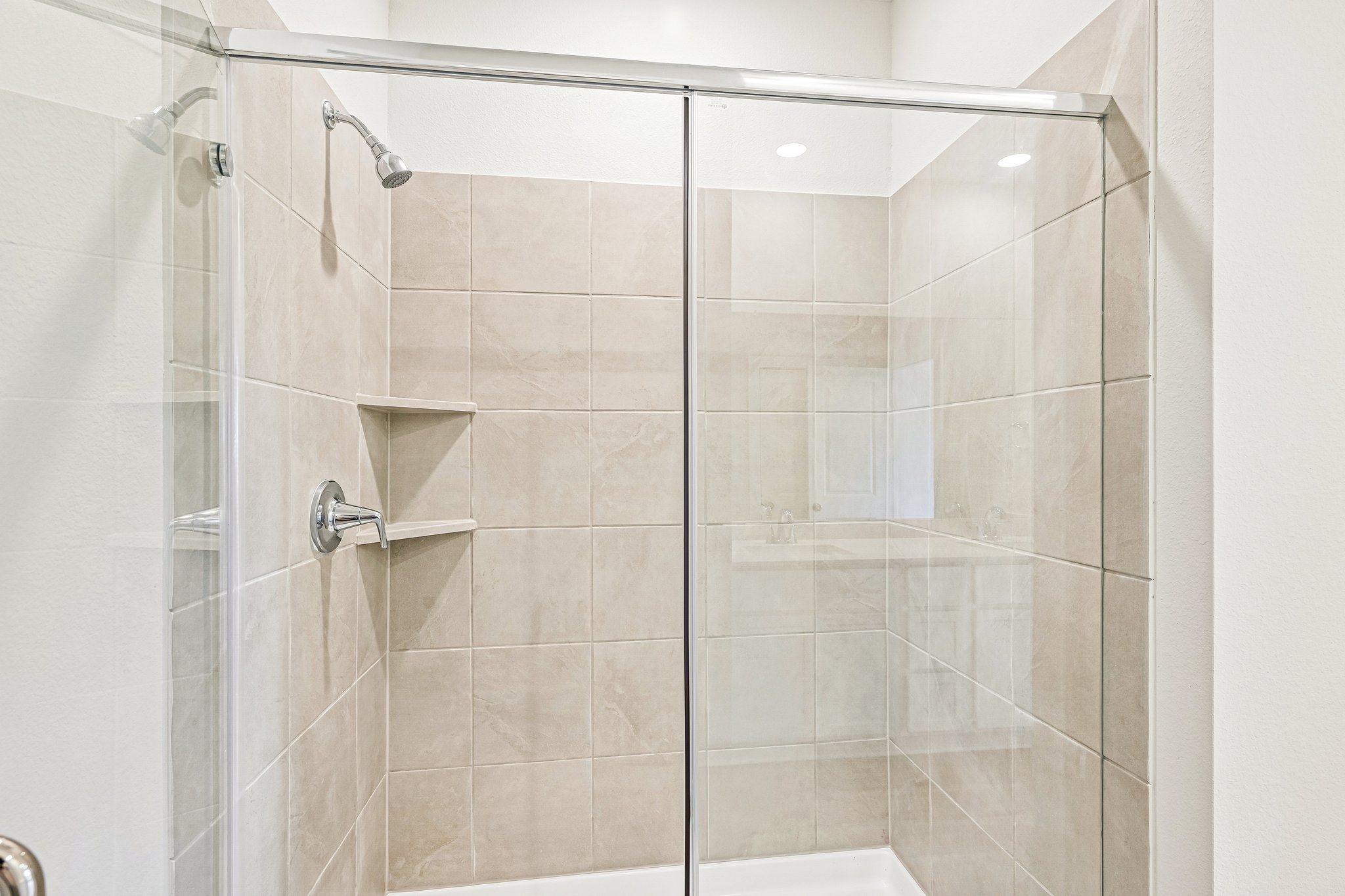 A shower with a glass door.