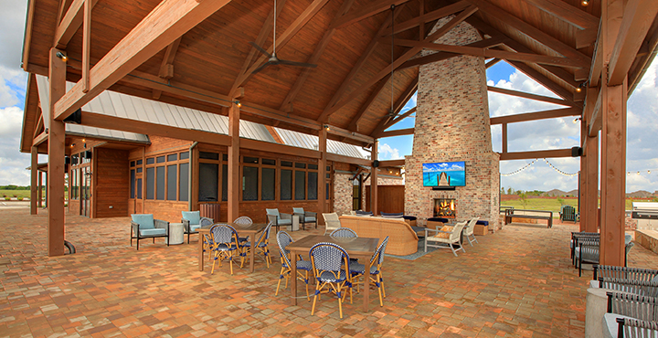 A patio with tables and chairs.
