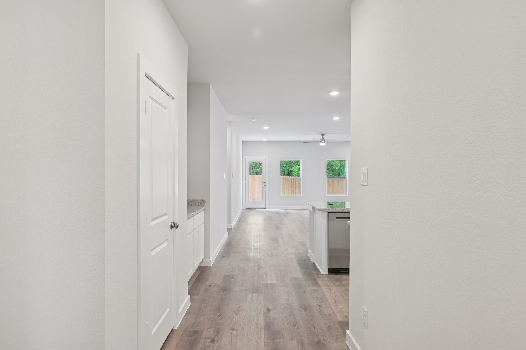 A hallway with white walls.