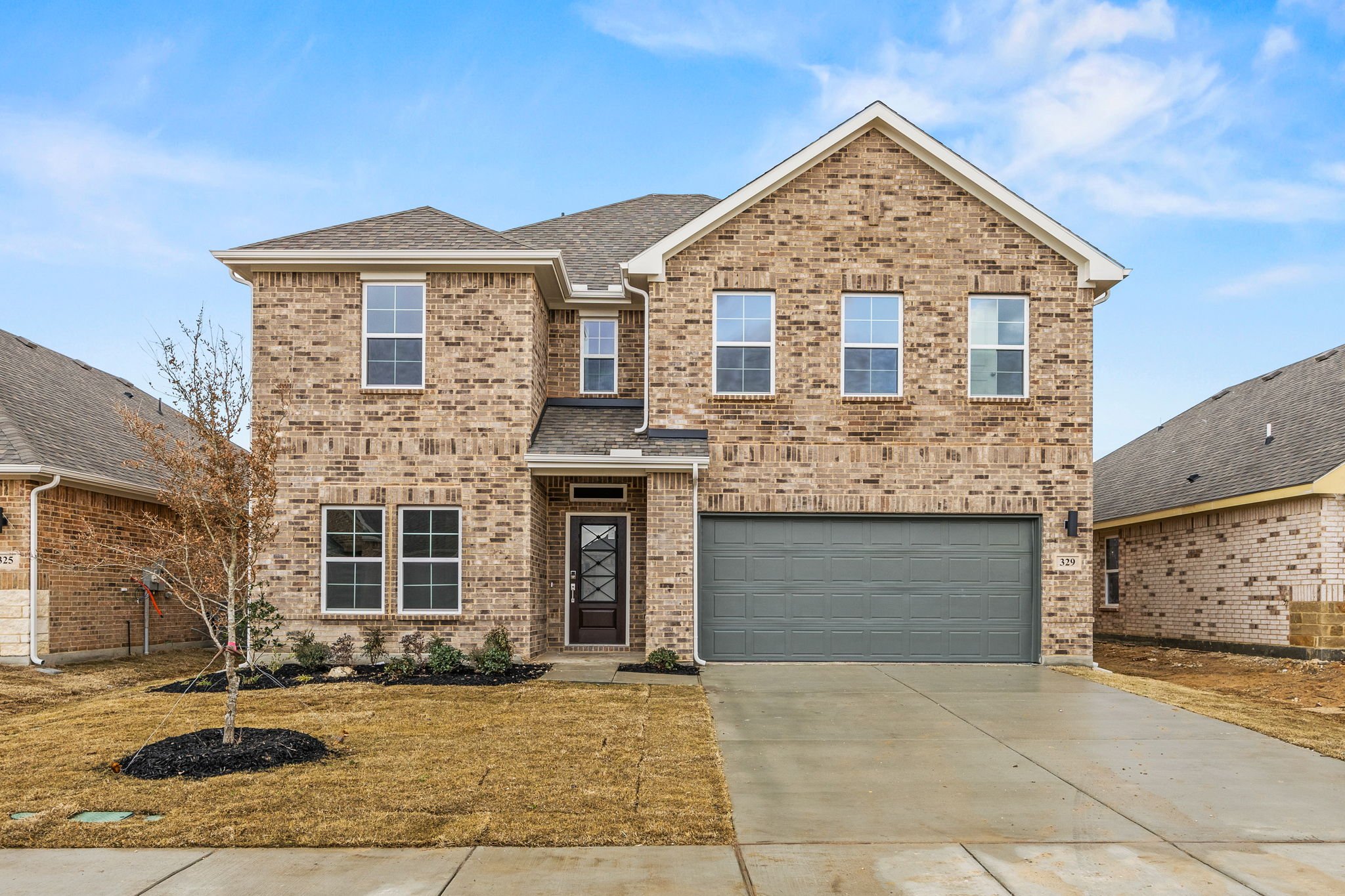 A brick building with a garage.