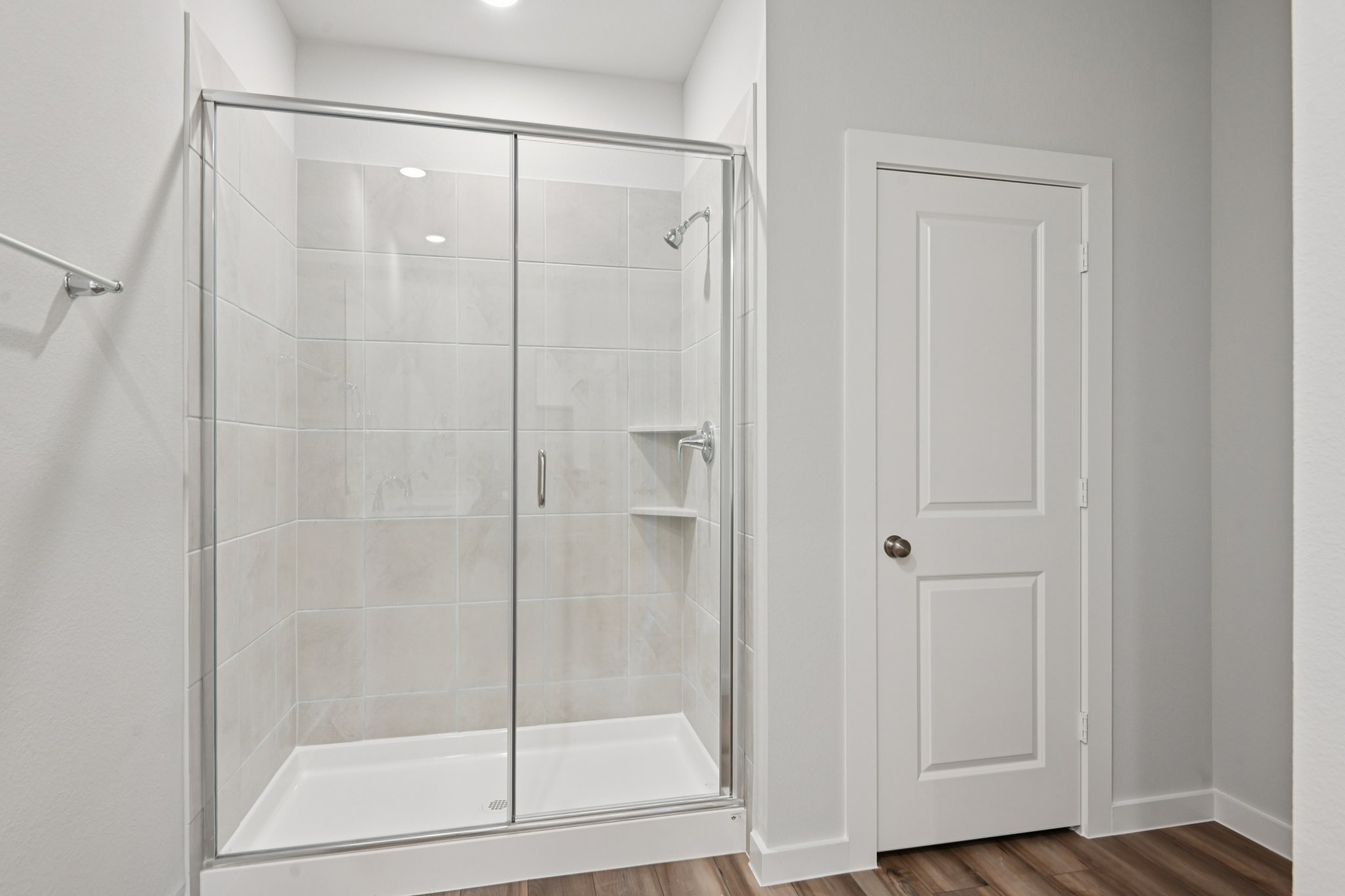 A shower with a glass door.