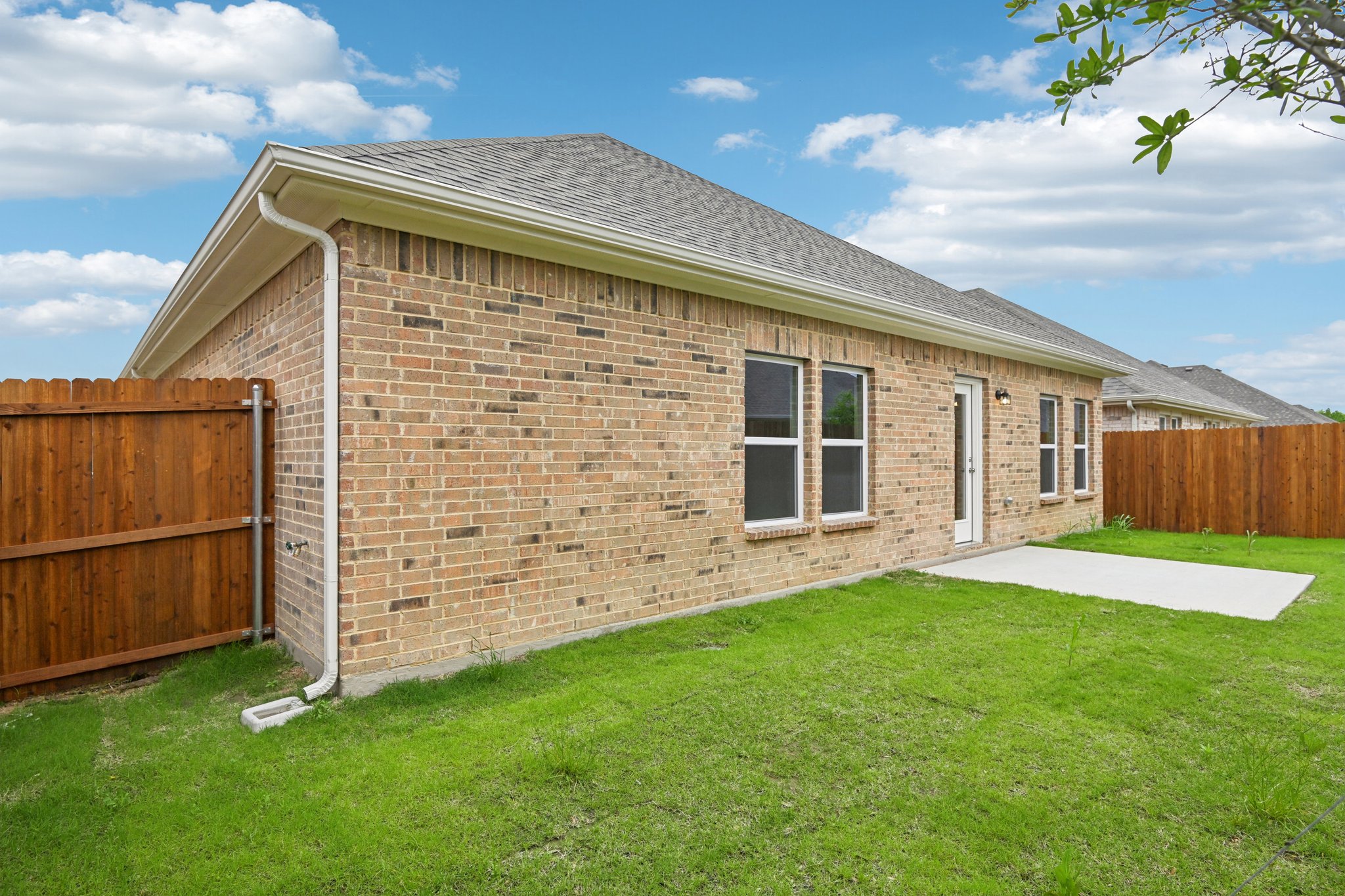 A brick house with a fence.