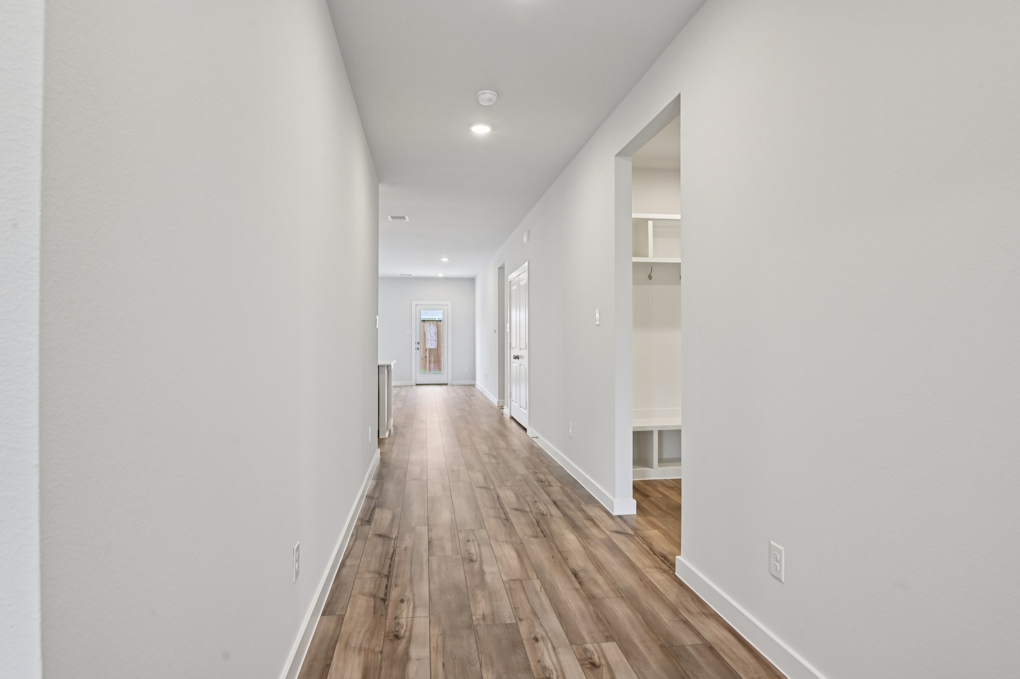 A hallway with white walls.
