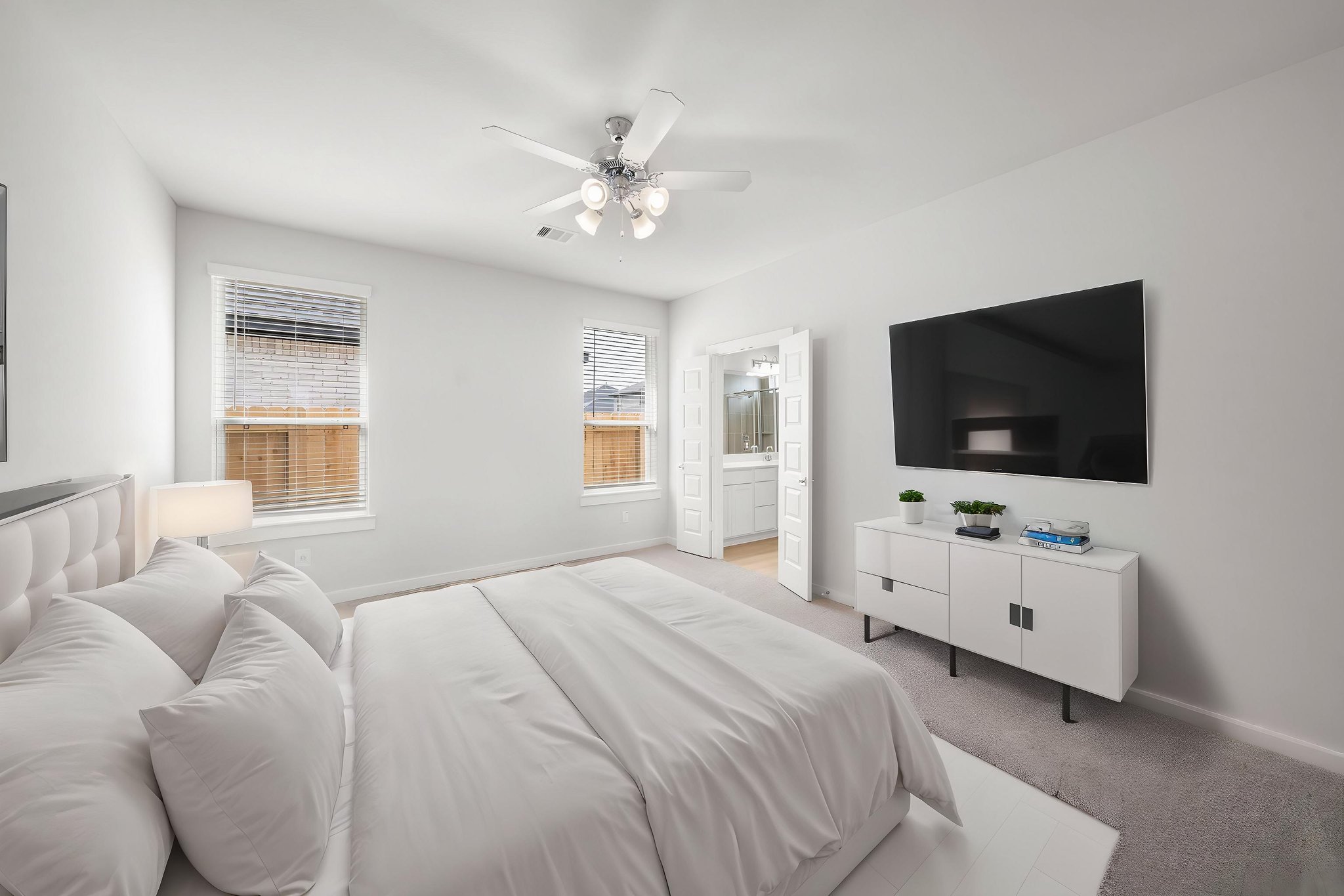 A living room with a white couch and a television.