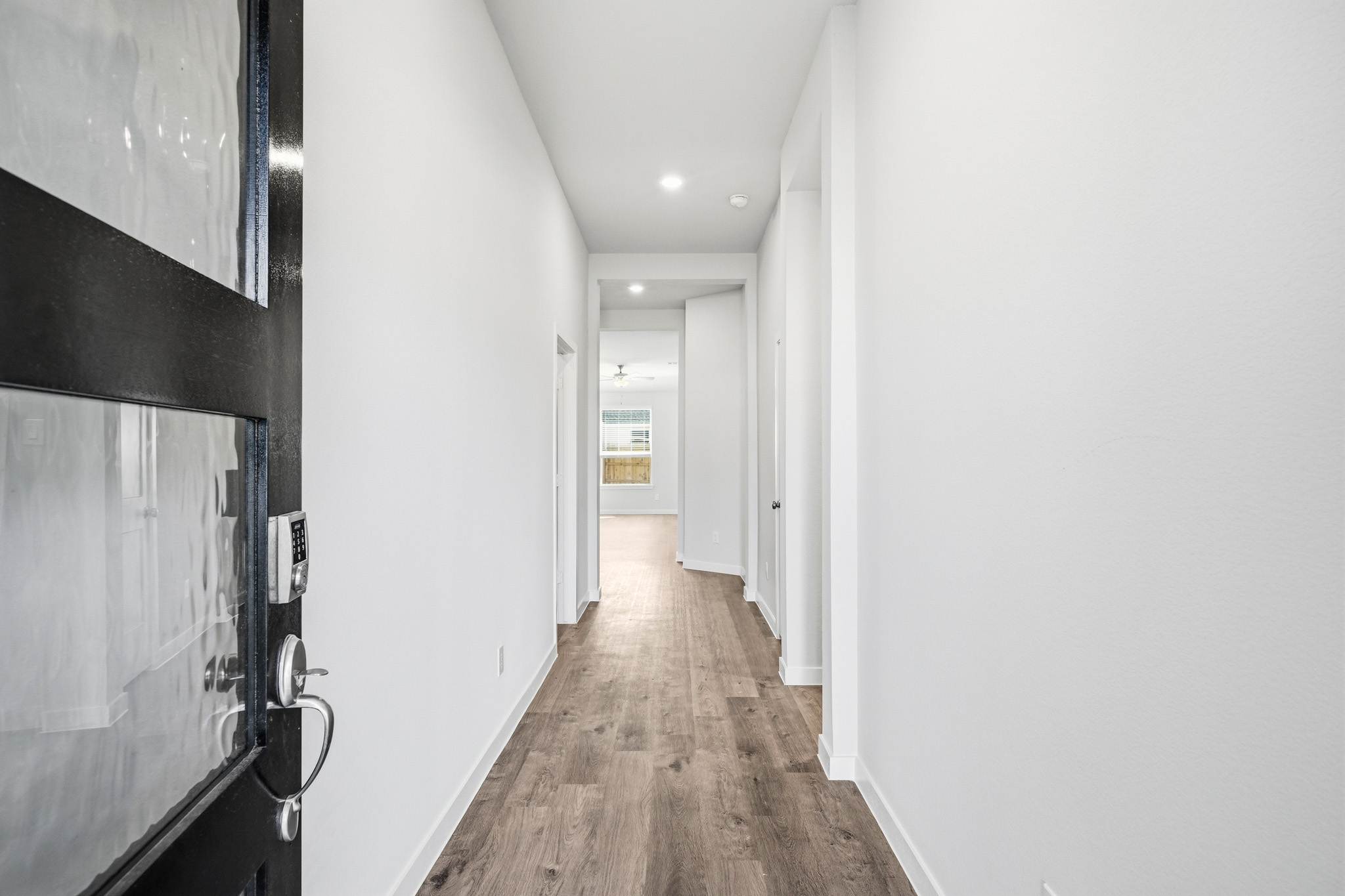 A hallway with white walls.