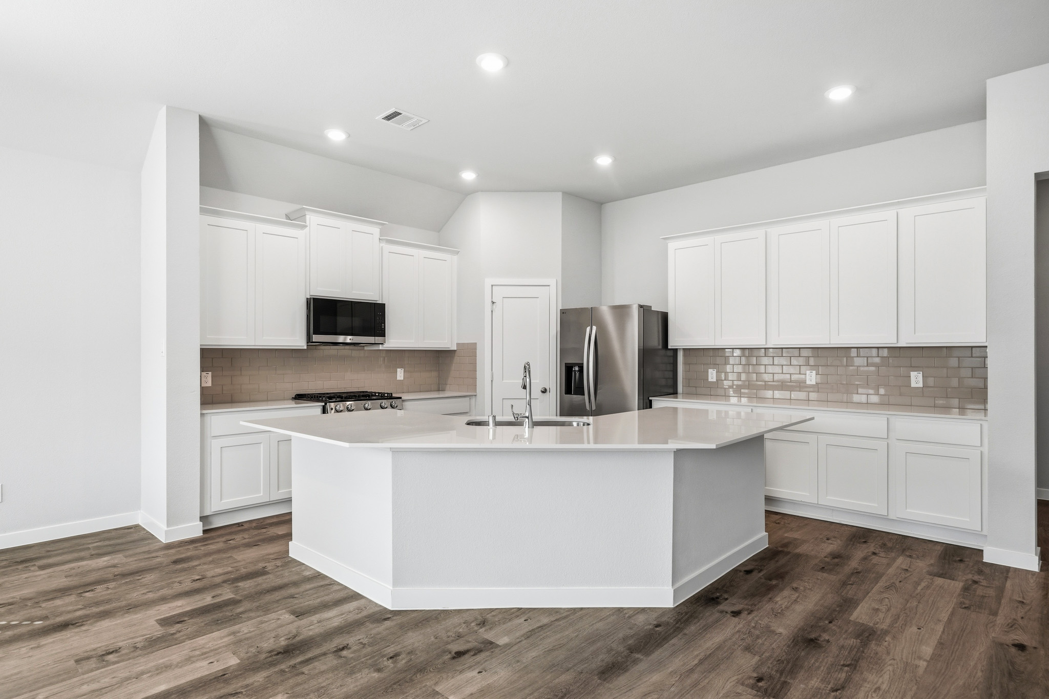 A kitchen with white cabinets.