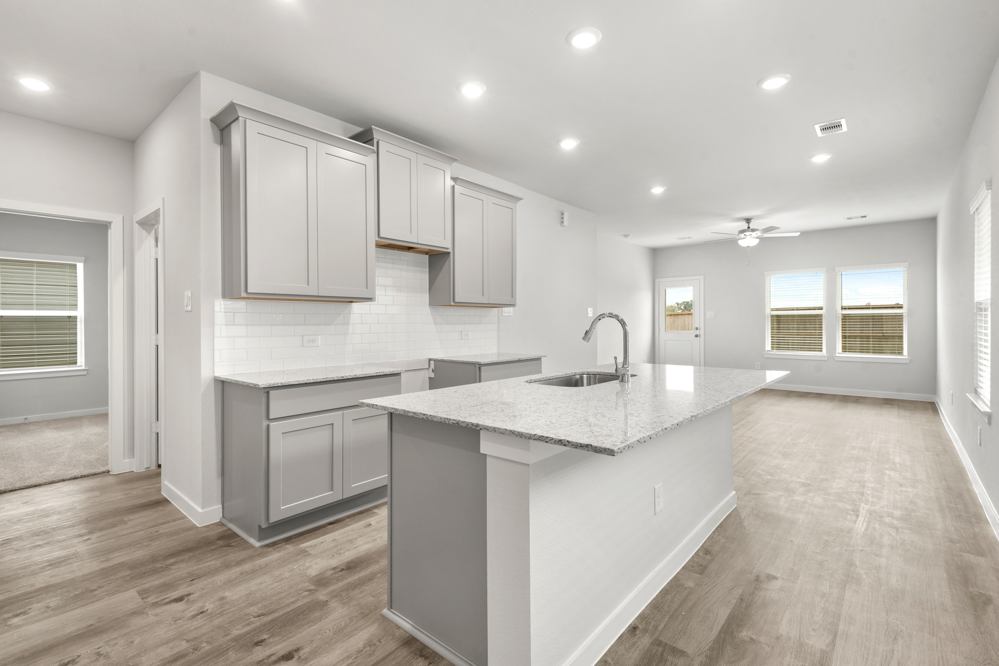 A kitchen with white cabinets.