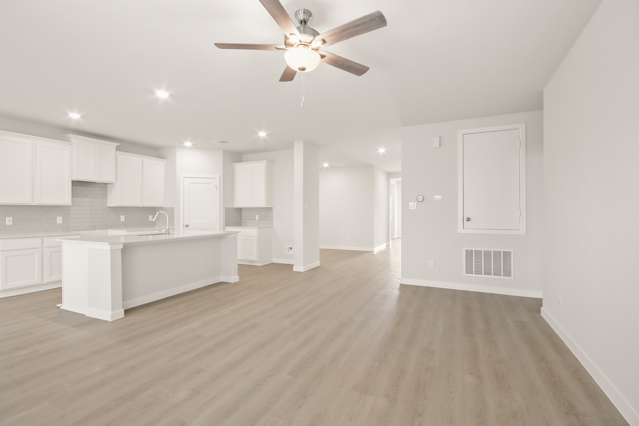 A kitchen with white cabinets.