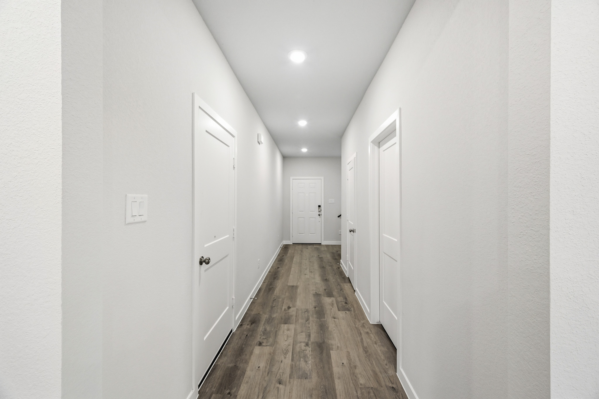 A hallway with white doors.
