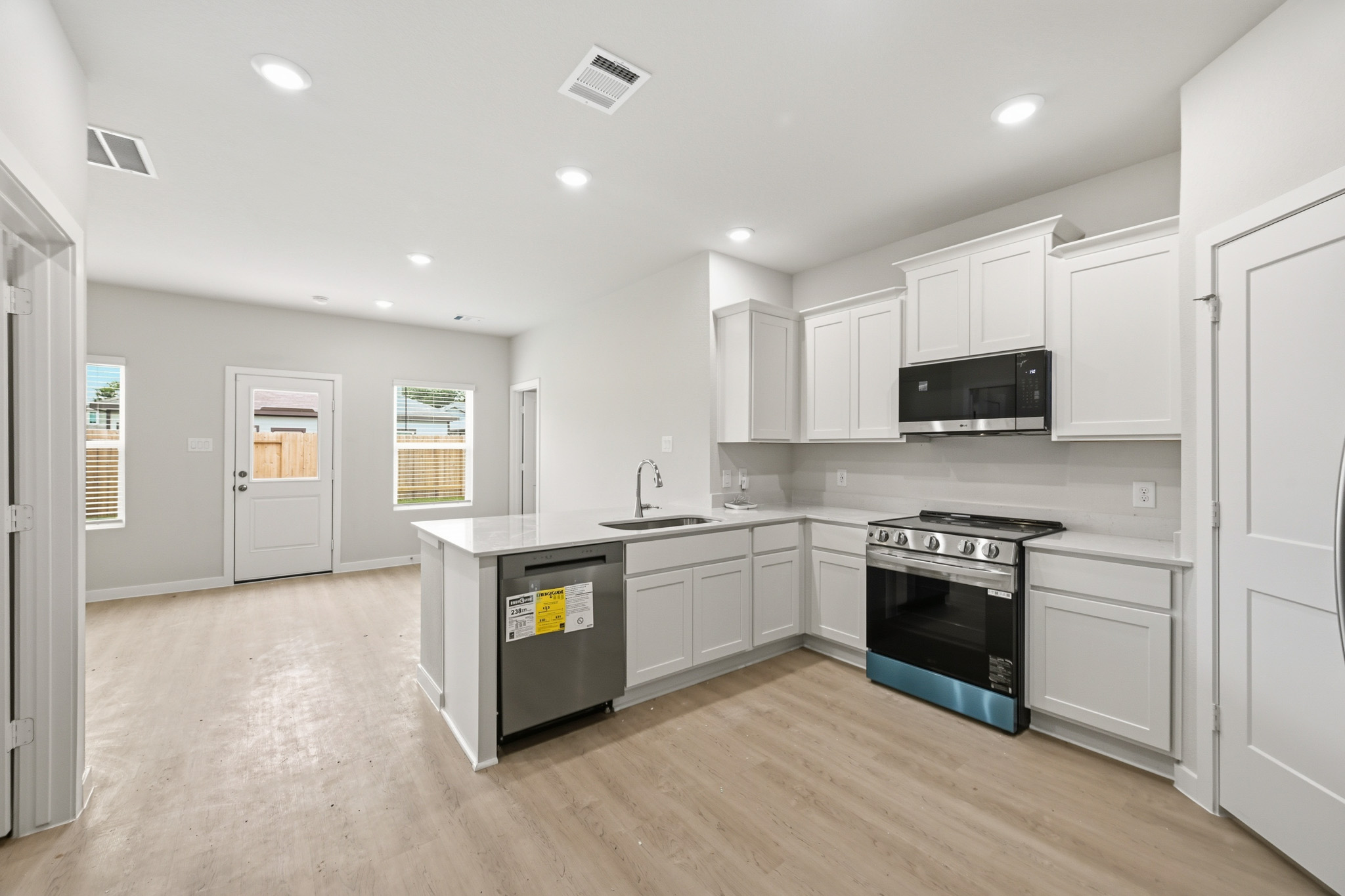 A kitchen with white cabinets.