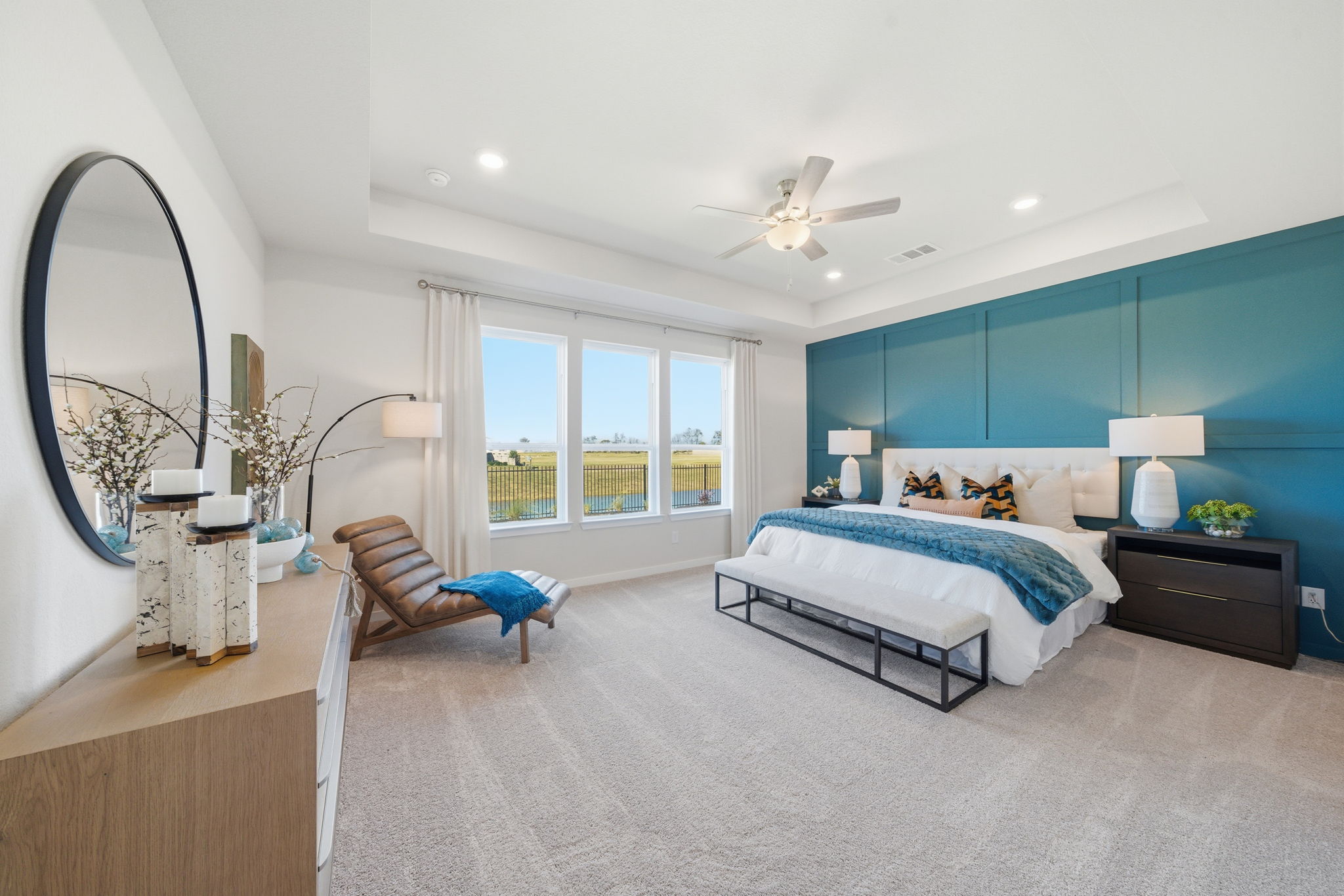 A bedroom with a large mirror.