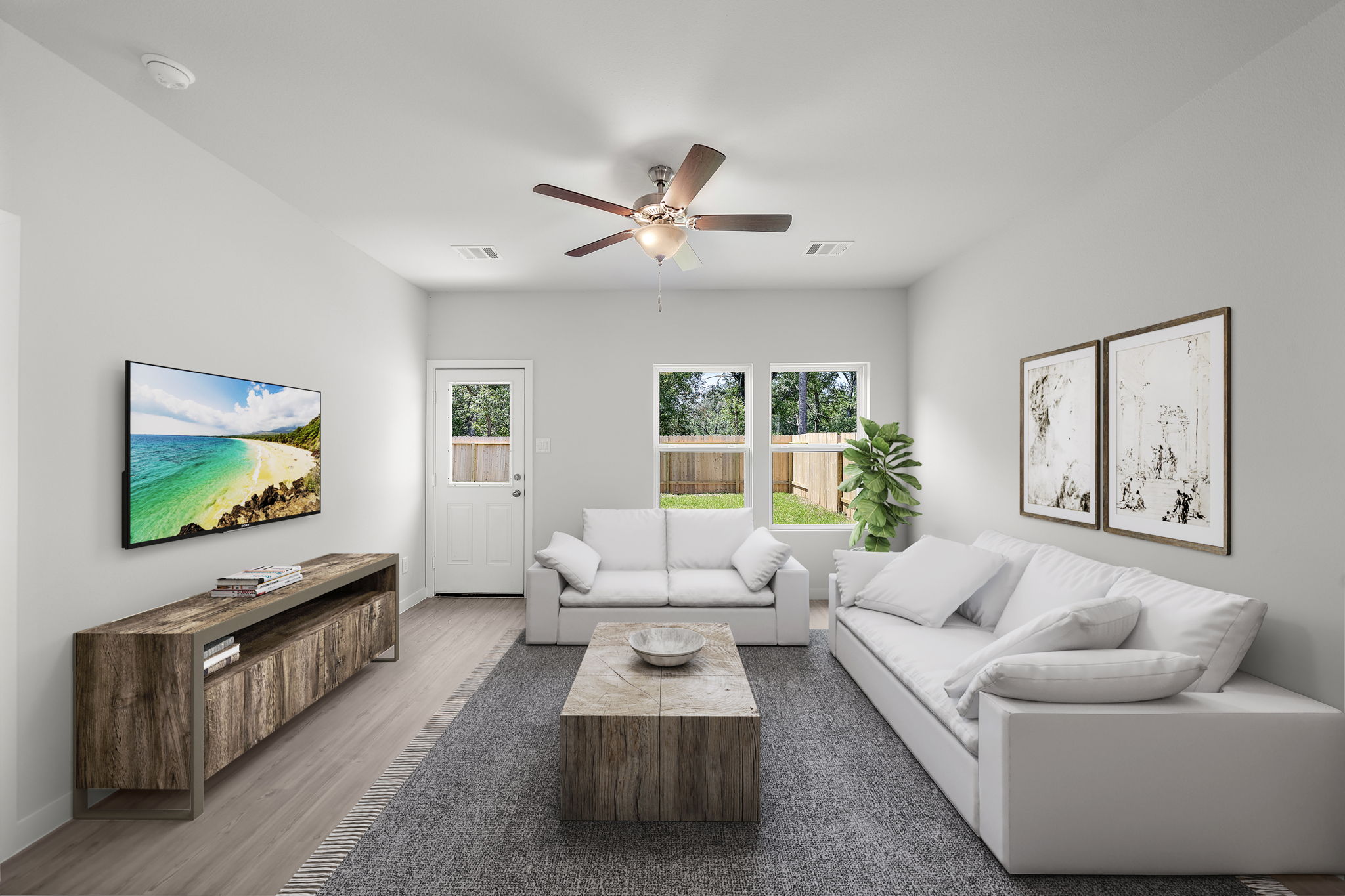 A living room with a white couch and a wood coffee table.