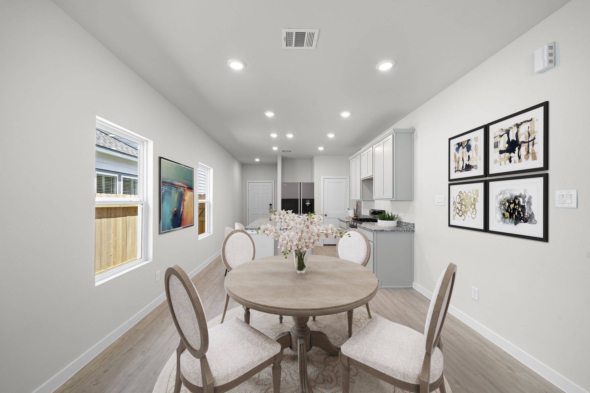 A dining room with a table and chairs.