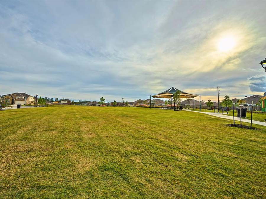 A grassy field with a building in the background.