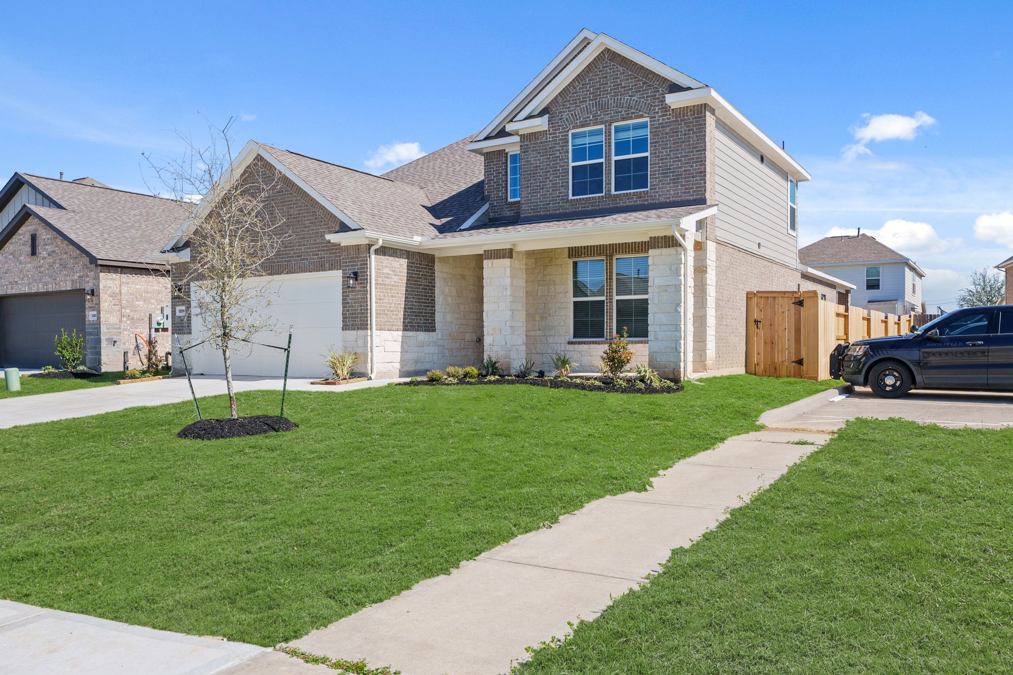 A house with a car parked in the driveway.