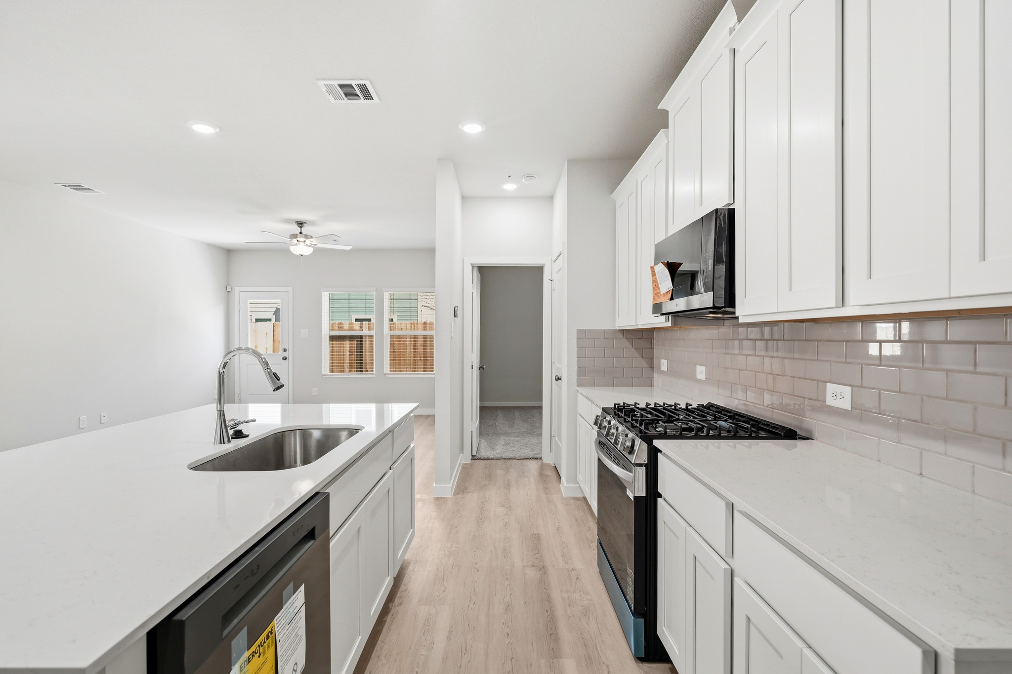 A kitchen with white cabinets.