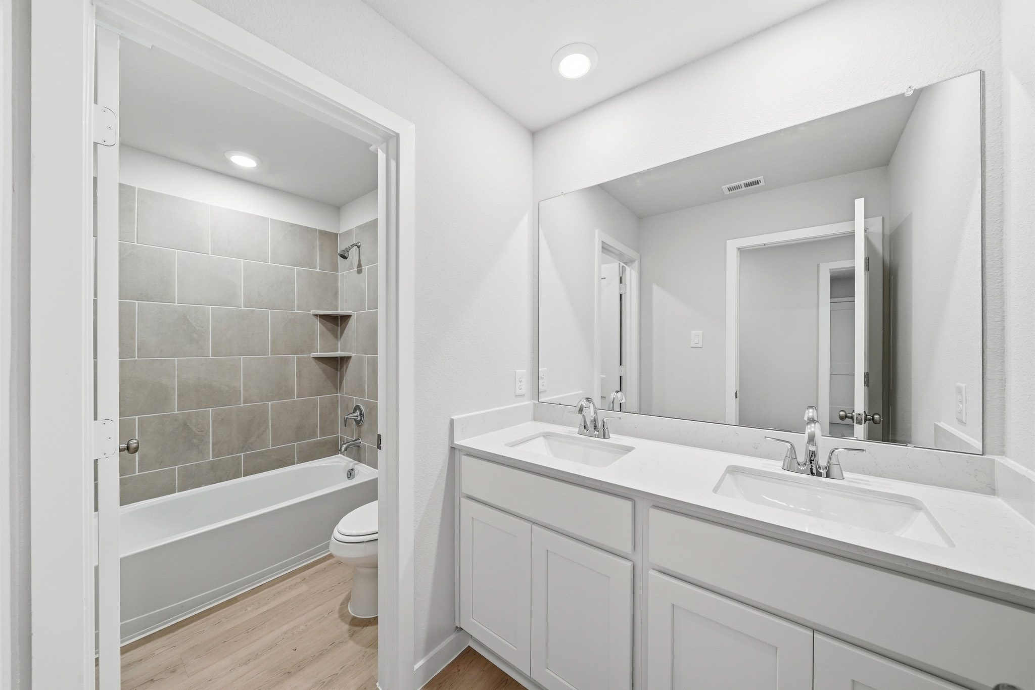 A bathroom with a tub sink and toilet.