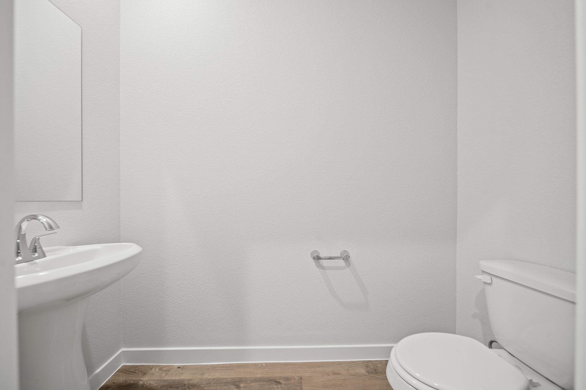 A bathroom with a toilet and sink.