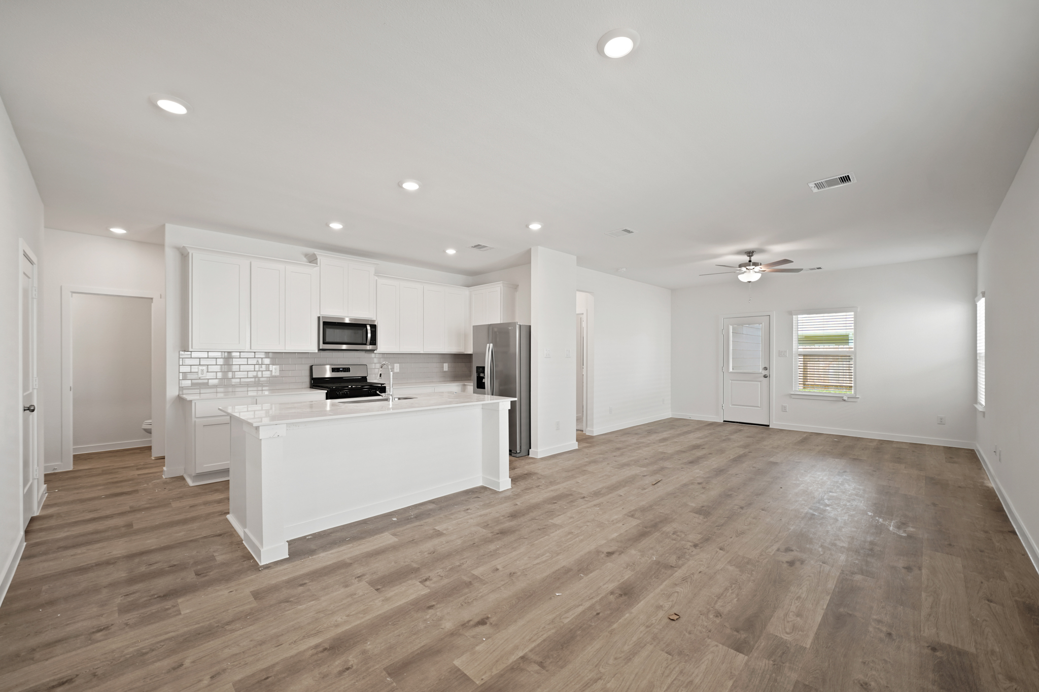 A large kitchen with white cabinets.