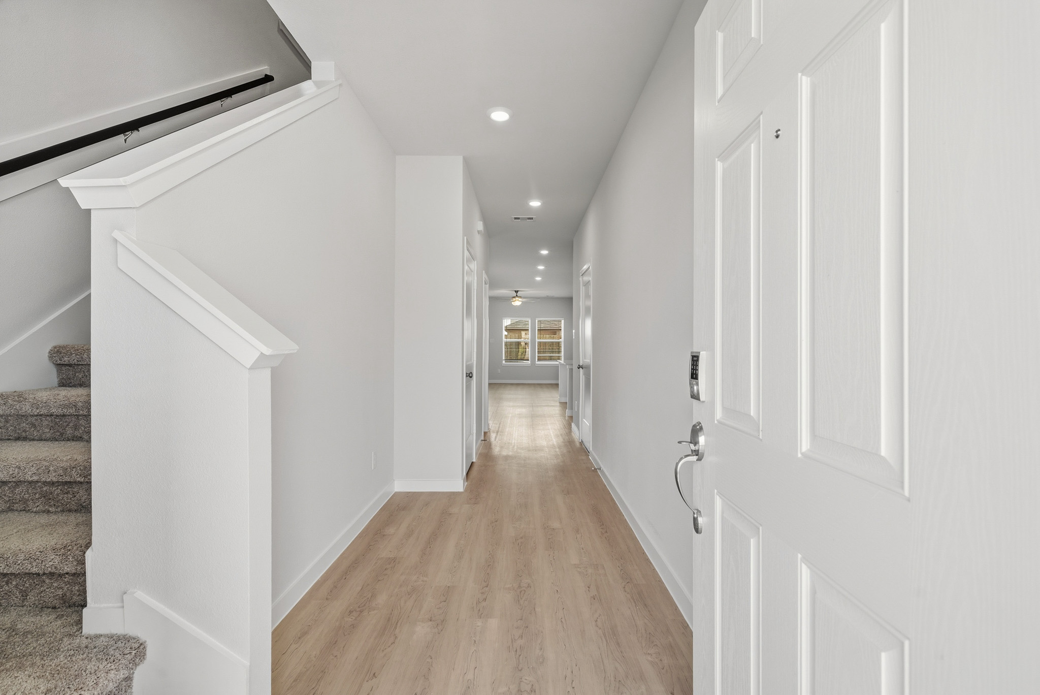 A hallway with white doors.