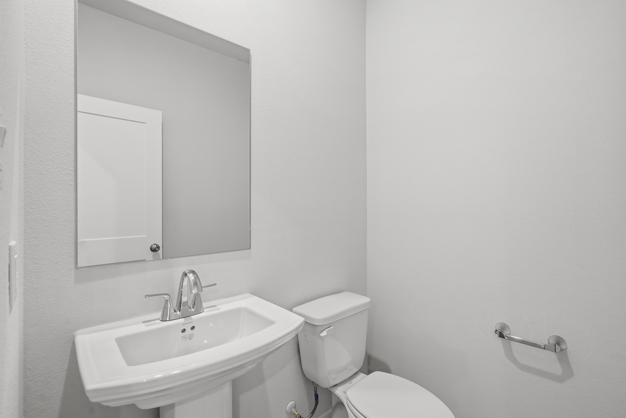 A bathroom with a sink and toilet.