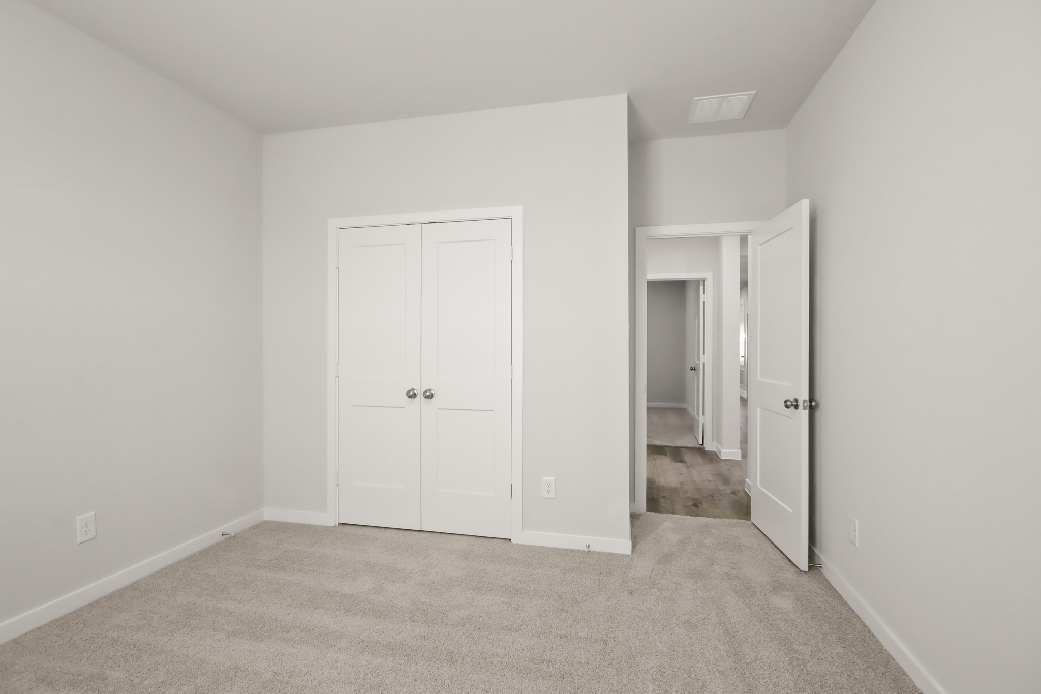 A hallway with white doors.