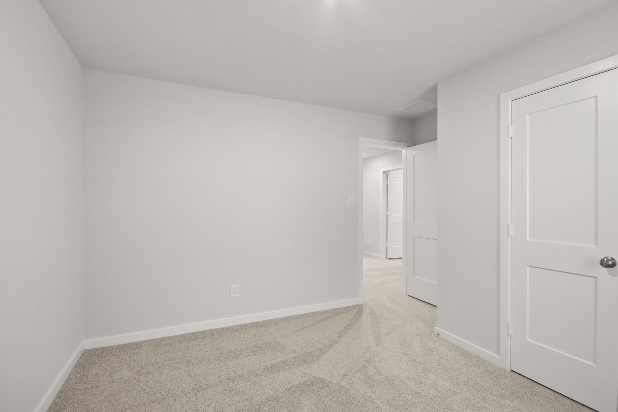A hallway with white doors.