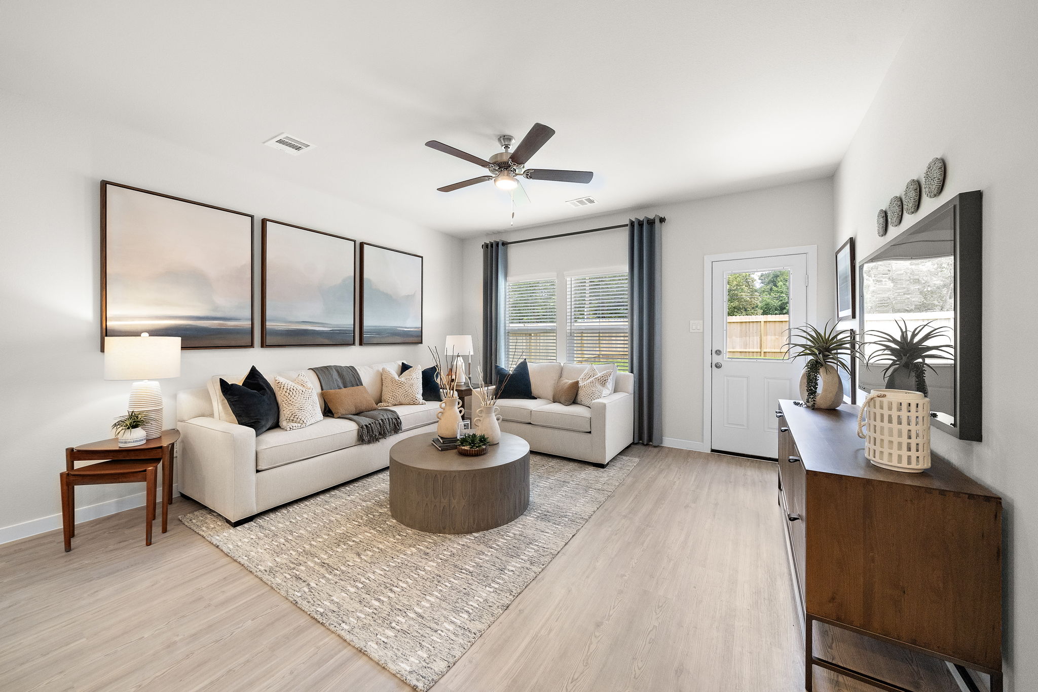 A living room with a large rug.