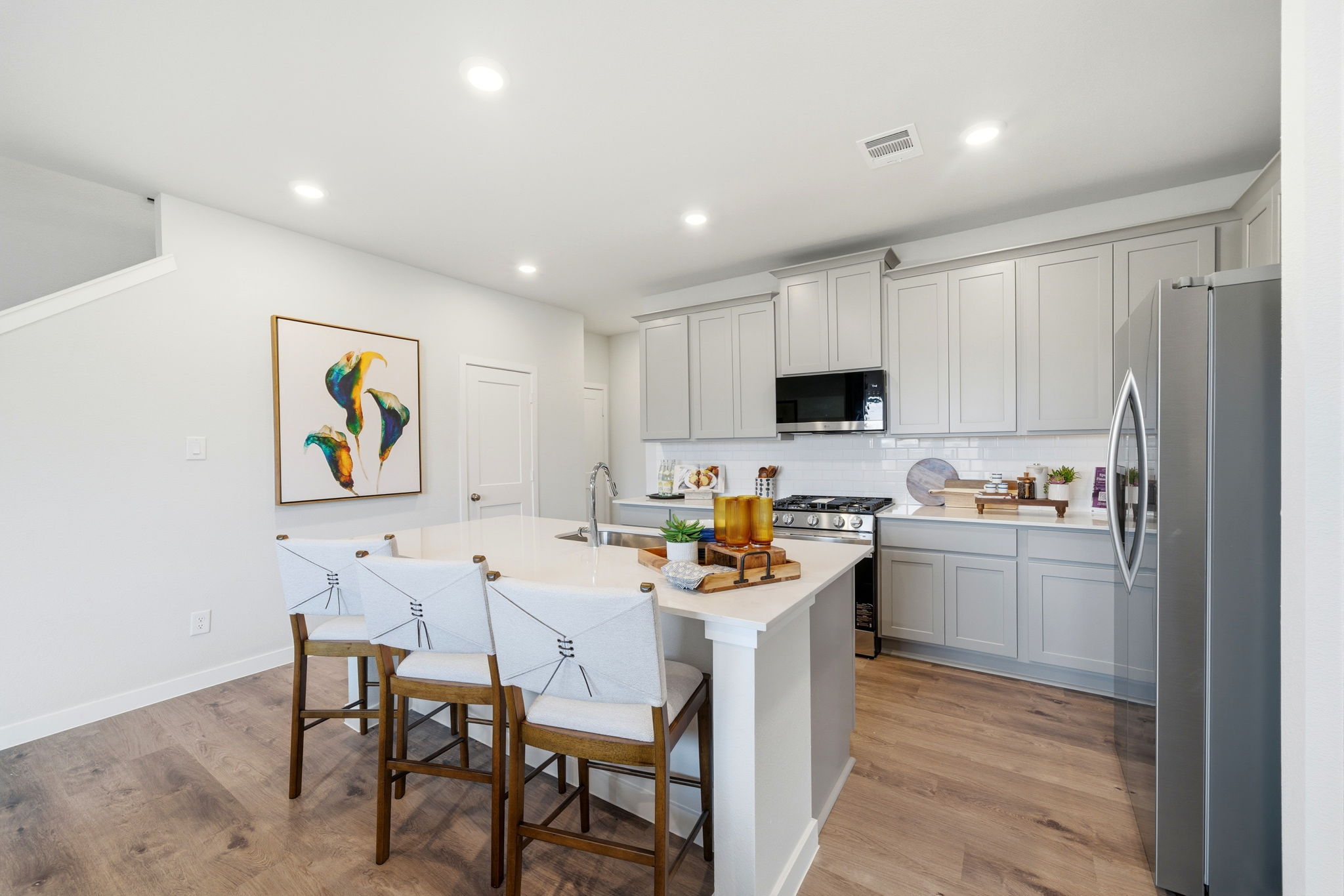 A kitchen with white cabinets.