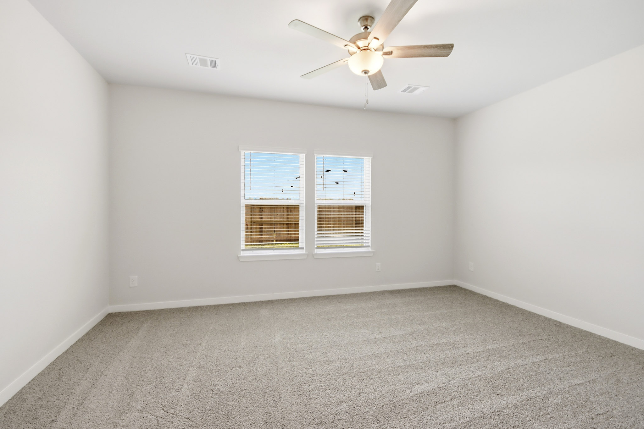 A room with a ceiling fan and a ceiling fan.