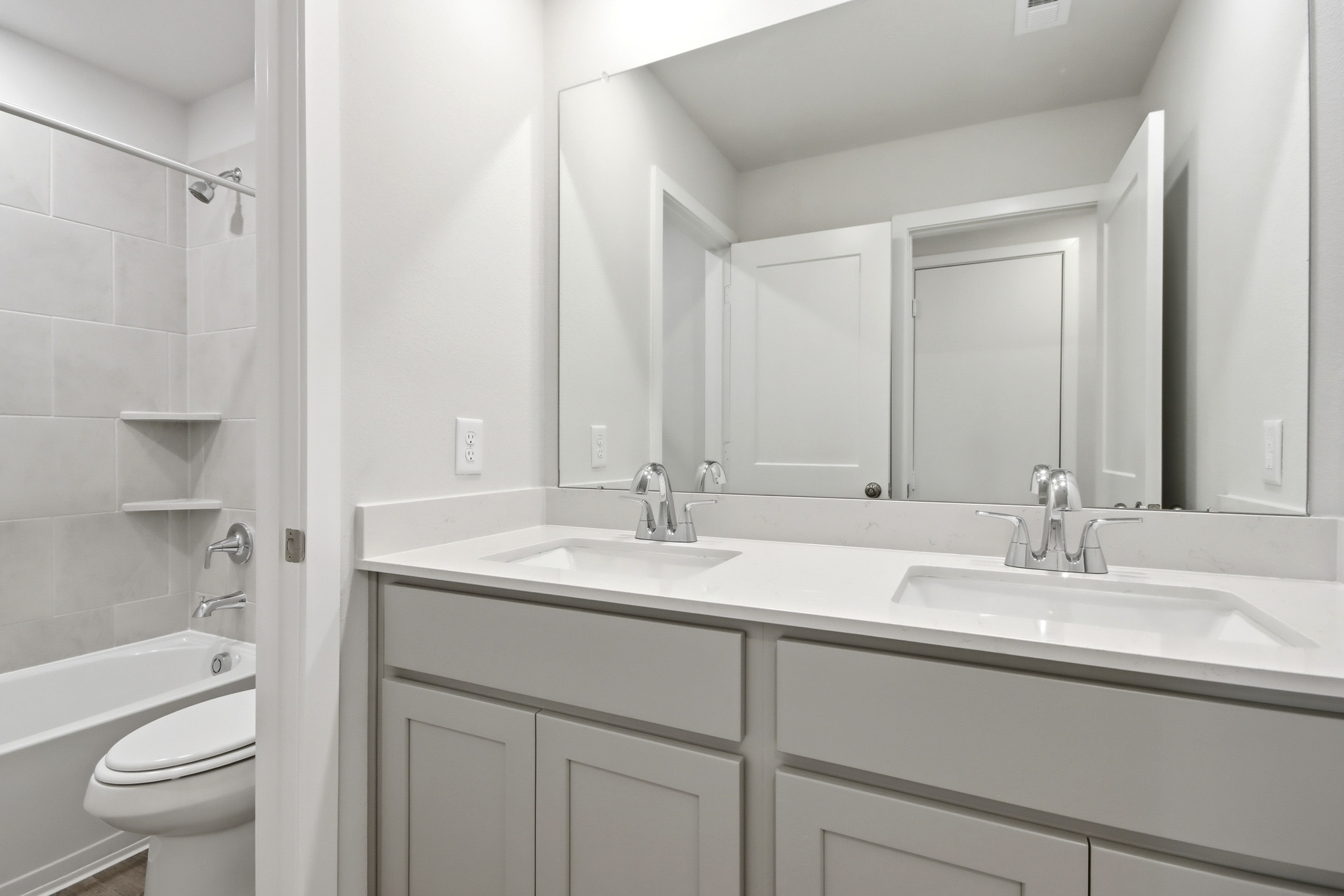 A bathroom with a sink and a toilet.