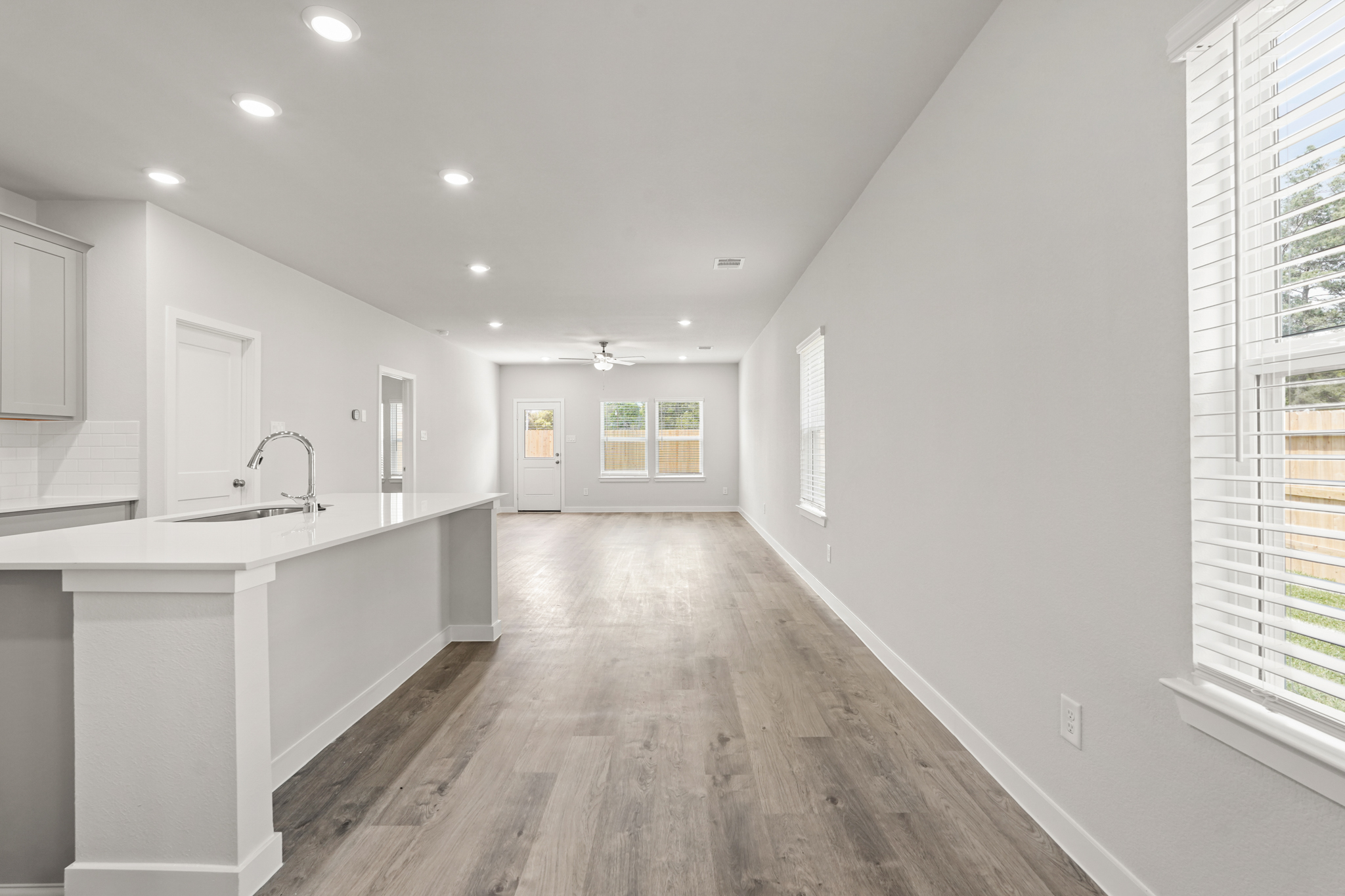 A kitchen with white cabinets.