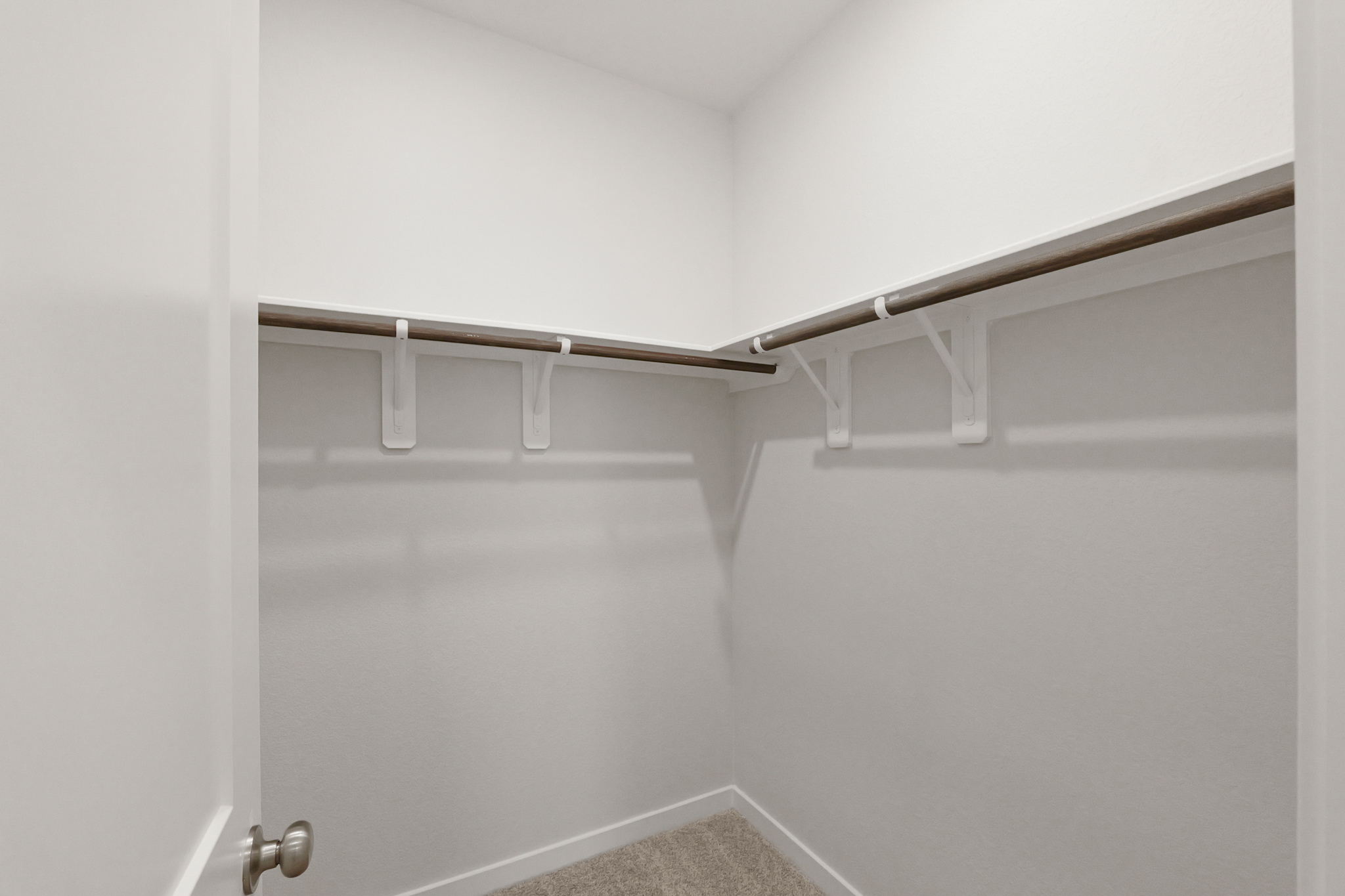 A white door with a metal bar.