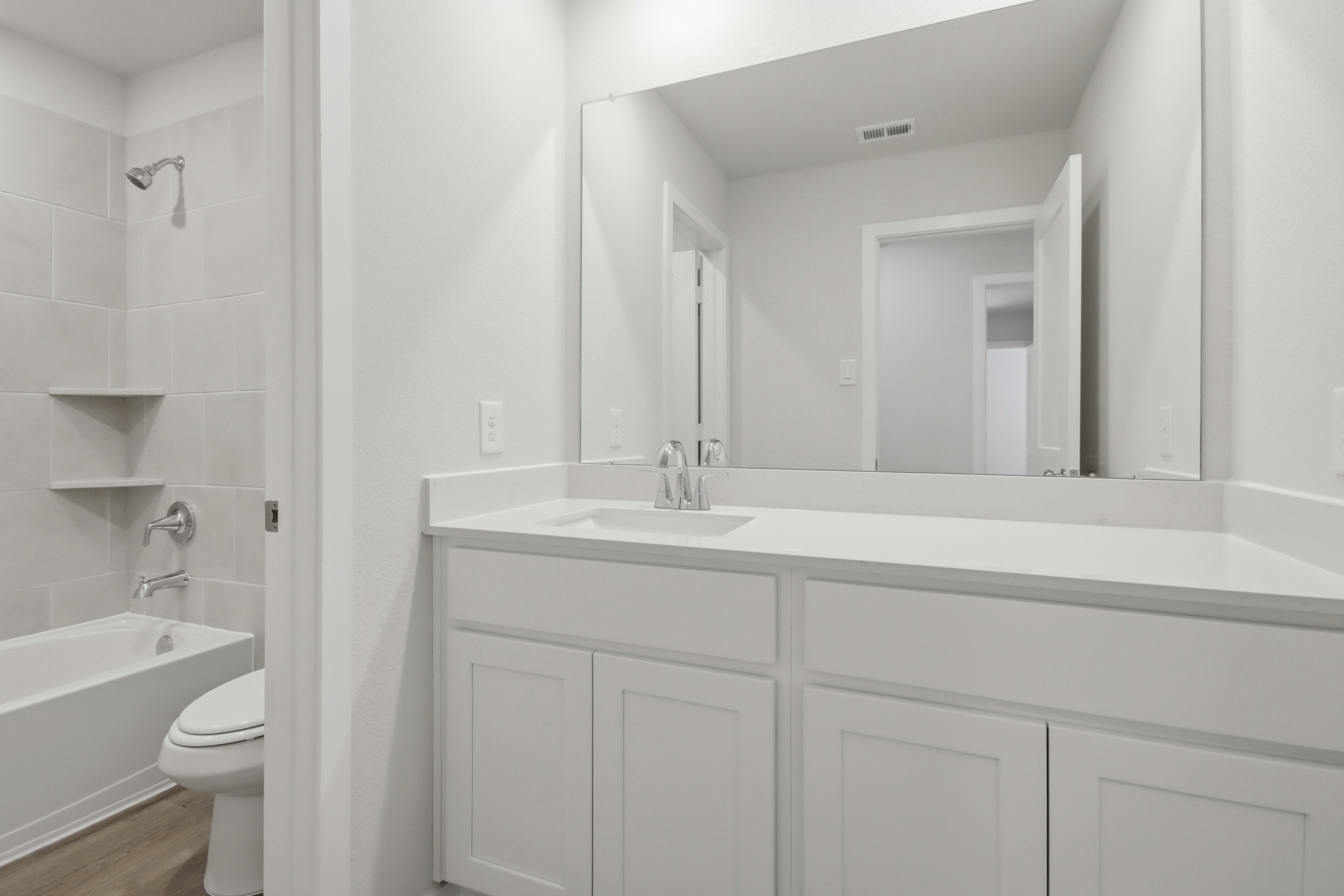 A bathroom with a tub sink and toilet.